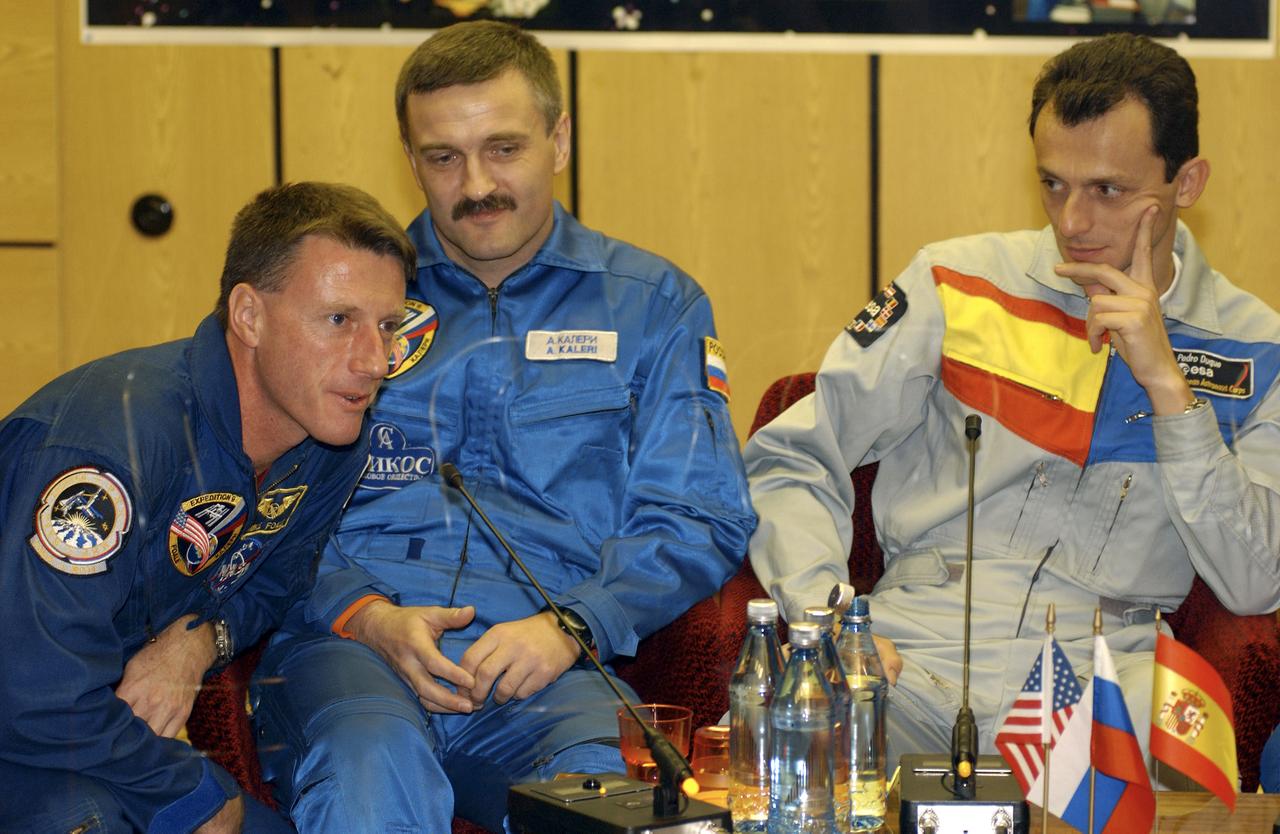 Expedition 8 Commander and NASA Science Officer Michael Foale, left, responds to a reporter's question as Expedition 8 Soyuz Commander Alexander Kaleri and European Space Agency astronaut Pedro Duque of Spain, right, look on during a prelaunch news conference, Friday, Oct. 17, 2003, in Baikonur, Kazakhstan. Photo Credit (NASA/Bill Ingalls)