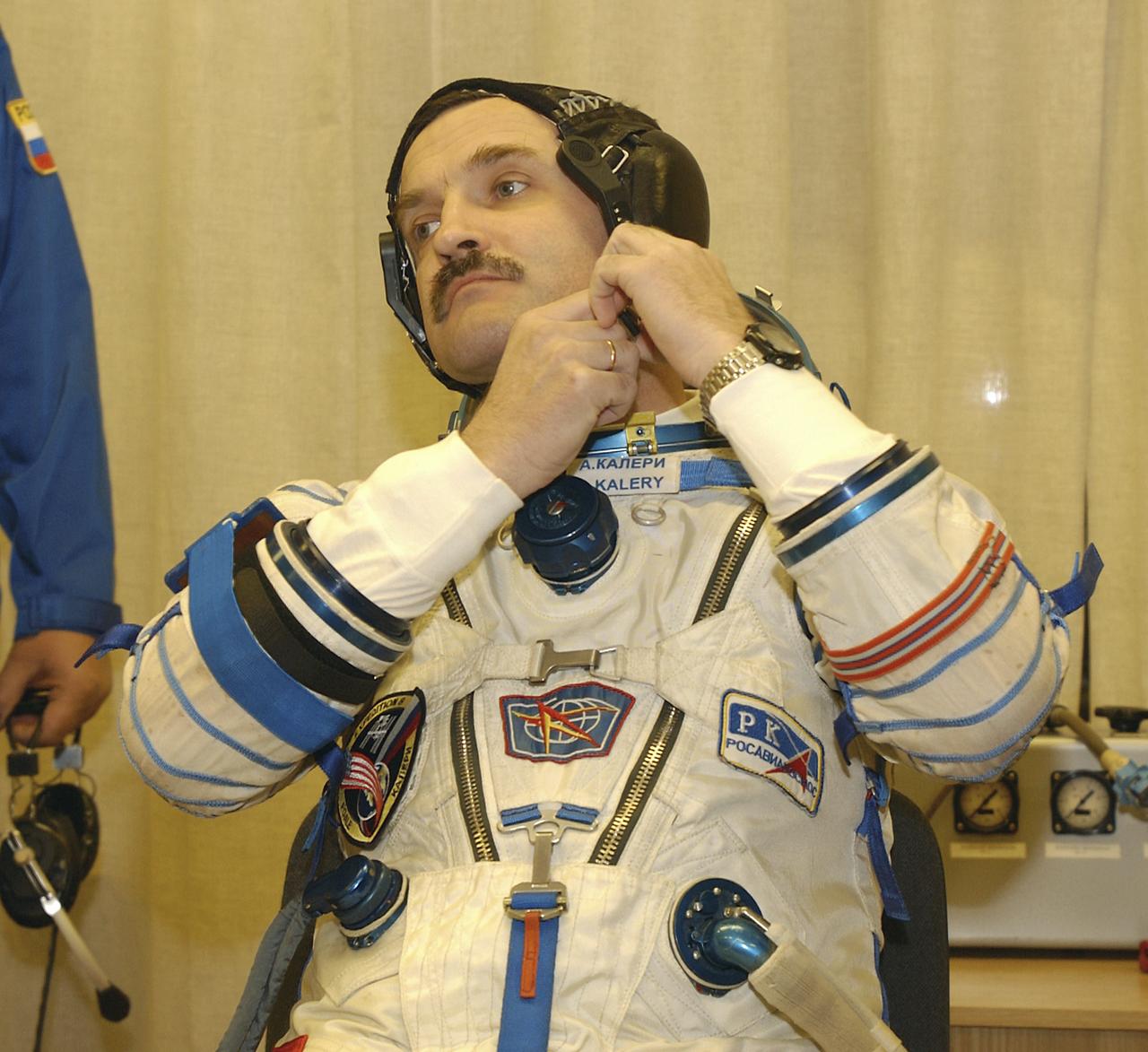 Expedition 8 Soyuz Commander Alexander Kaleri suits up, Saturday, Oct. 18, 2003 at the Baikonur Cosmodrome in Kazakhstan prior to his departure for the launch pad with Expedition 8 Commander and NASA Science Officer Mike Foale and European Space Agency astronaut Pedro Duque. The trio were launched on a Soyuz TMA-3 vehicle to the International Space Station, arriving on Oct. 20.Photo Credit (NASA/Bill Ingalls)