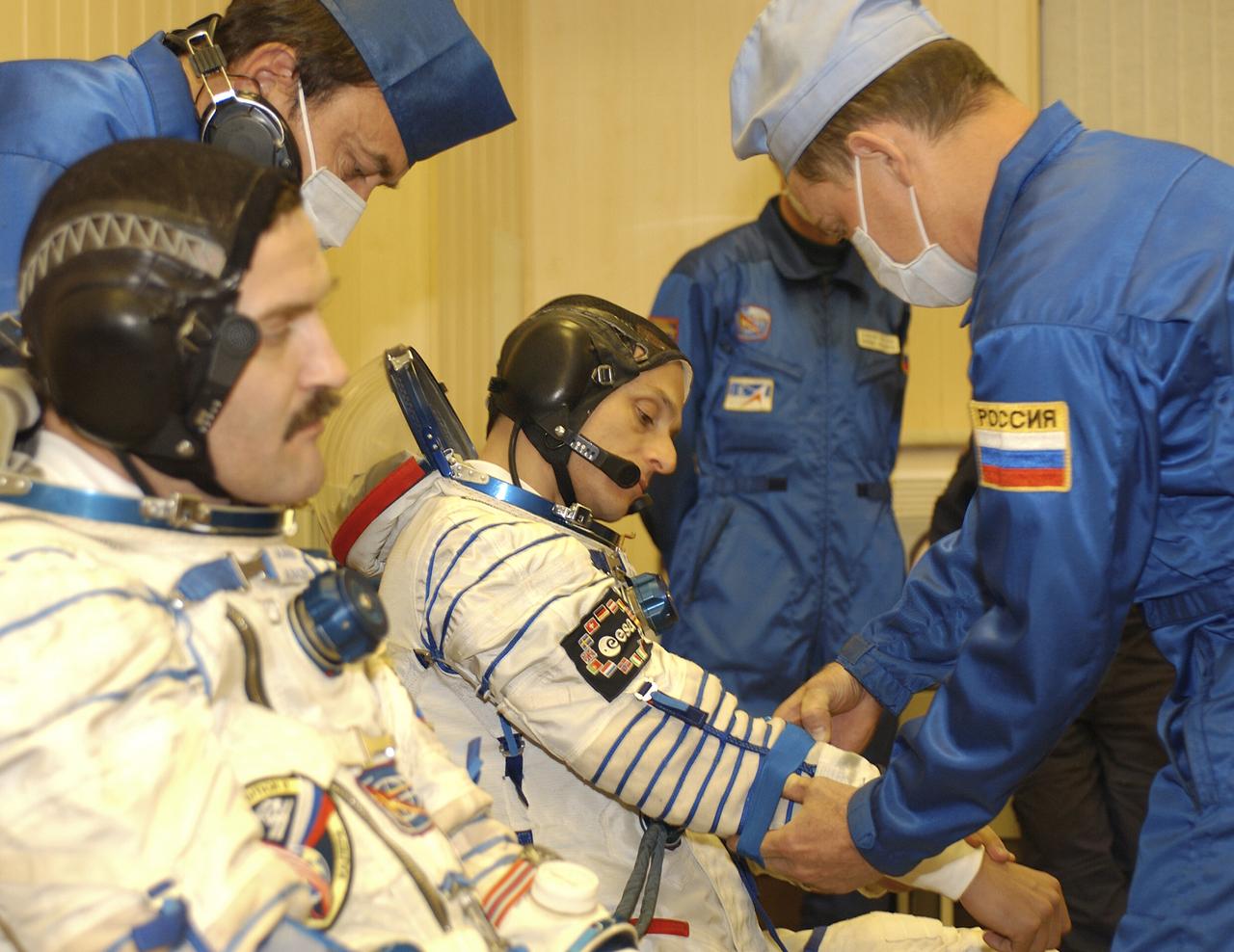 Expedition 8 Soyuz Commander Alexander Kaleri, left and European Space Agency astronaut Pedro Duque of Spain suit up for launch, Saturday, Oct. 18, 2003, prior to departure for the launch pad at the Baikonur Cosmodrome in Kazakhstan. Expedition 8 Commander and NASA Science Officer Mike Foale, Kaleri and Duque. were launched on the Soyuz TMA-3 vehicle to the International Space Station, arriving on Oct. 20. Photo Credit (NASA/Bill Ingalls)
