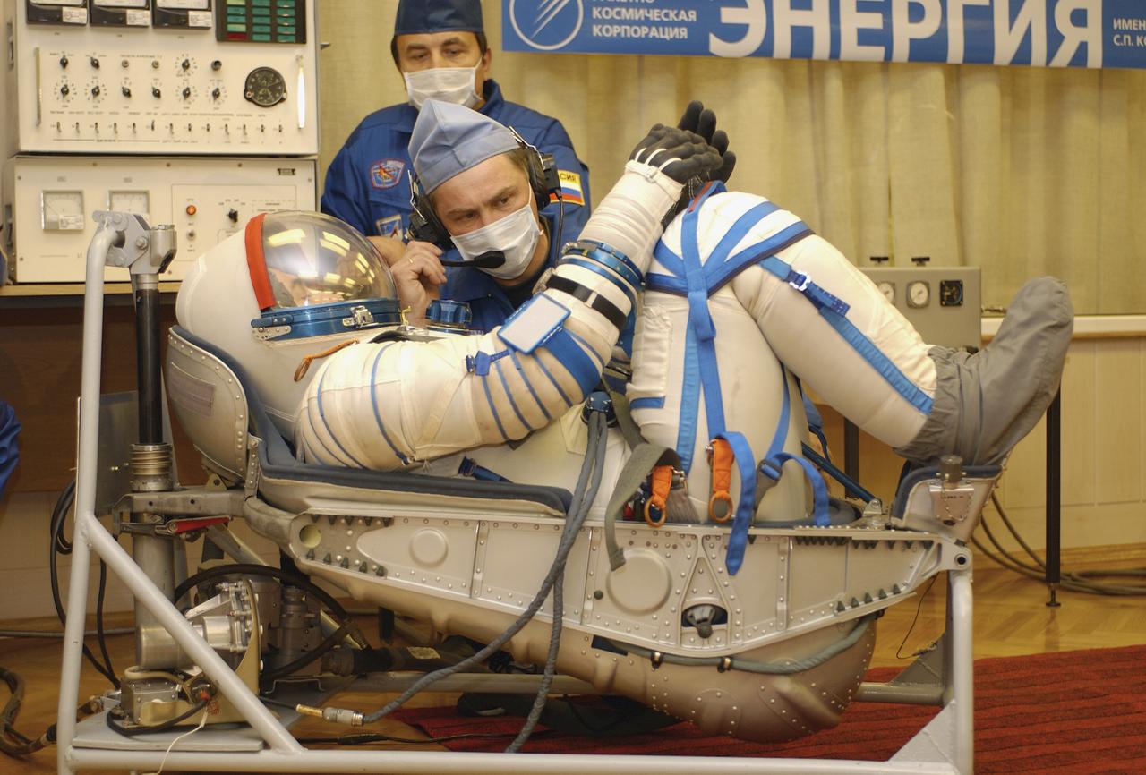 Technicians conduct a leak check on the spacesuit of Expedition 8 Soyuz Commander Alexander Kaleri at the Baikonur Cosmodrome, Saturday, Oct. 18, 2003, prior to his departure for the launch pad with Expedition 8 Commander and NASA Science Officer Mike Foale and European Space Agency astronaut Pedro Duque of Spain. The trio were launched on a Soyuz TMA-3 vehicle to the International Space Station, arriving on Oct. 20. Photo Credit (NASA/Bill Ingalls)