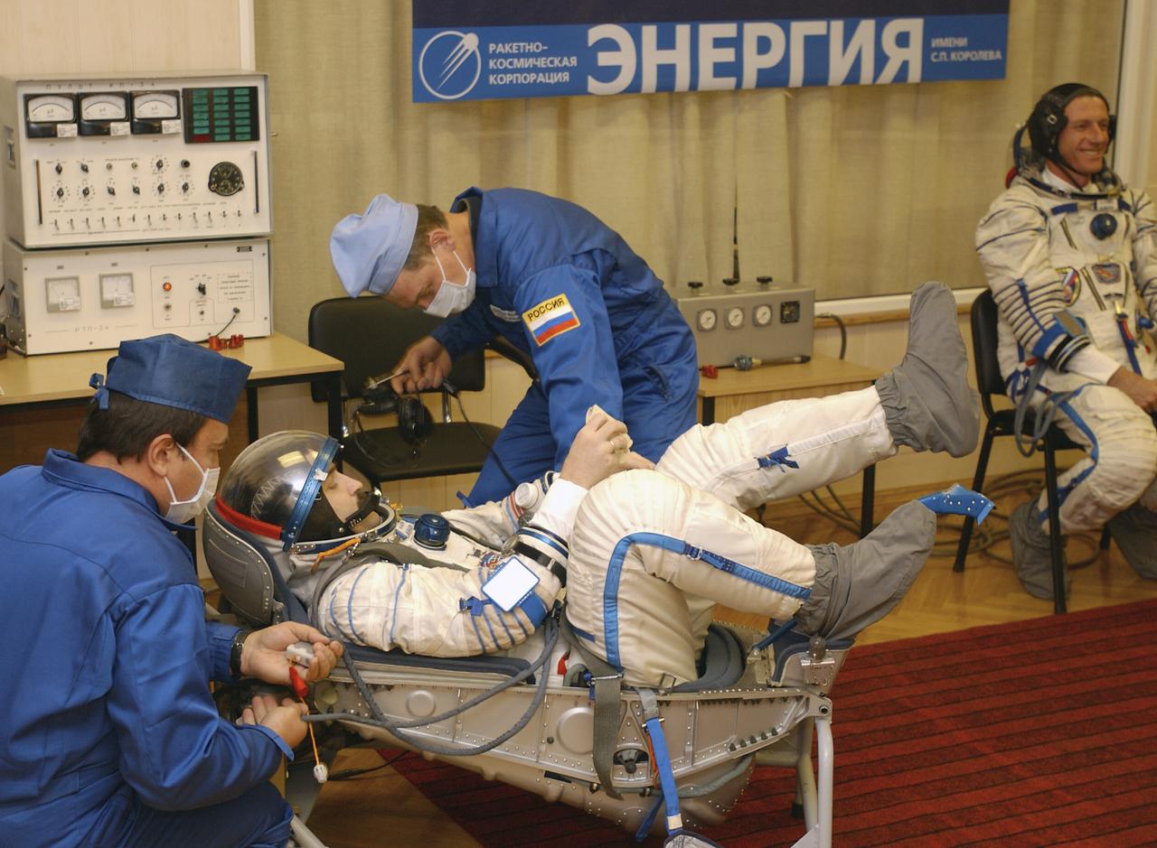 Technicians conduct a leak check on the spacesuit of Expedition 8 Soyuz Commander Alexander Kaleri at the Baikonur Cosmodrome, Saturday, Oct. 18, 2003, prior to his departure for the launch pad with Expedition 8 Commander and NASA Science Officer Mike Foale and European Space Agency astronaut Pedro Duque of Spain. The trio were launched on a Soyuz TMA-3 vehicle to the International Space Station, arriving on Oct. 20. Photo Credit (NASA/Bill Ingalls)