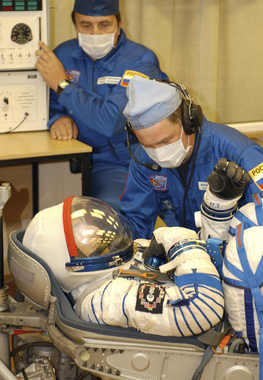 Technicians conduct a leak check on the spacesuit of European Space Agency astronaut Pedro Duque of Spain at the Baikonur Cosmodrome, Saturday, Oct. 18, 2003, prior to his departure for the launch pad with Expedition 8 Commander and NASA Science Officer Mike Foale and Soyuz Commander Alexander Kaleri. The trio were launched on a Soyuz TMA-3 vehicle to the International Space Station, arriving on Oct. 20. Photo Credit (NASA/Bill Ingalls)