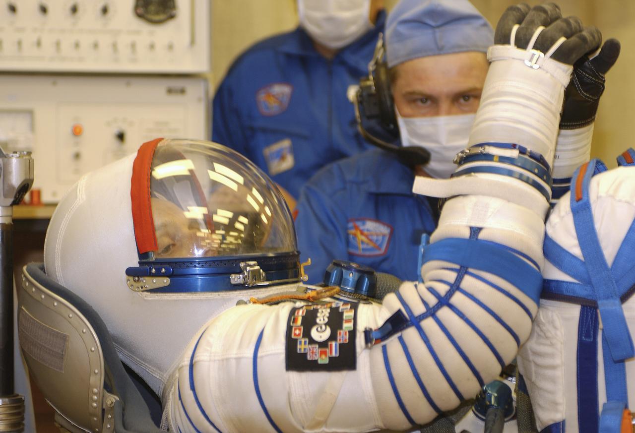 Technicians conduct a leak check on the spacesuit of European Space Agency astronaut Pedro Duque of Spain at the Baikonur Cosmodrome, Saturday, Oct. 18, 2003, prior to his departure for the launch pad with Expedition 8 Commander and NASA Science Officer Mike Foale and Soyuz Commander Alexander Kaleri. The trio were launched on a Soyuz TMA-3 vehicle to the International Space Station, arriving on Oct. 20. Photo Credit (NASA/Bill Ingalls)