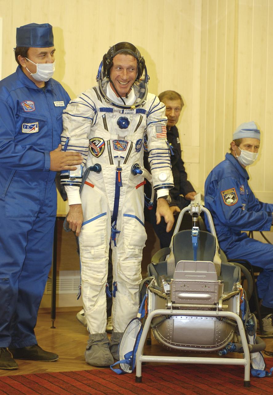 Expedition 8 Commander and NASA Science Officer Michael Foale completes suiting up at the Baikonur Cosmodrome in Kazakhstan, Saturday, Oct. 18, 2003, prior to departing for the launch pad with Expedition 8 Soyuz Commander Alexander Kaleri and European Space Agency astronaut Pedro Duque of Spain. The trio were launched on the Soyuz TMA-3 vehicle to the International Space Station, arriving on Oct. 20. Photo Credit (NASA/Bill Ingalls)