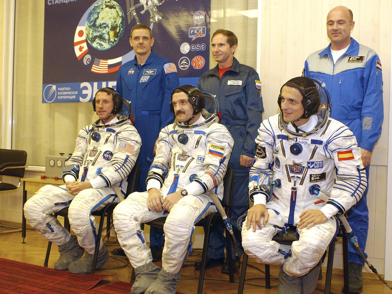 The prime and backup crews for Expedition 8 and European Space Agency crew members prepare to depart the suitup room at the Baikonur Cosmodrome in Kazakhstan, Saturday, Oct. 18, 2003 for the launch of the Soyuz TMA-3 vehicle to the International Space Station. Seated in the front row are Expedition 8 Commander and NASA Science Officer Michael Foale, left, Expedition 8 Soyuz Commander Alexander Kaleri and the ESA's Pedro Duque of Spain, right. Standing behind them are backup Expedition 8 Commander Bill McArthur, backup Soyuz Commander Valery Tokarev and backup ESA crewmember Andre Kuipers of the Netherlands. Photo Credit (NASA/Bill Ingalls)