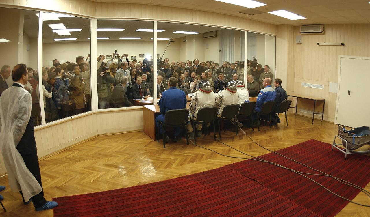With a throng of reporters looking on, the prime and backup crews for the Expedition 8 mission to the International Space Station and the prime and backup European Space Agency Astronauts receive final well-wishes from Russian and U.S. space officials at the Baikonur Cosmodrome in Kazakhstan, Saturday, Oct. 18, 2003, before heading to the launch pad. Expedition 8 Commander and NASA Science Officer Michael Foale, Expedition 8 Soyuz Commander Alexander Kaleri and ESA's Pedro Duque of Spain were launched on a Soyuz TMA-3 vehicle, arriving at the ISS on Oct. 20. Photo Credit (NASA/Bill Ingalls)