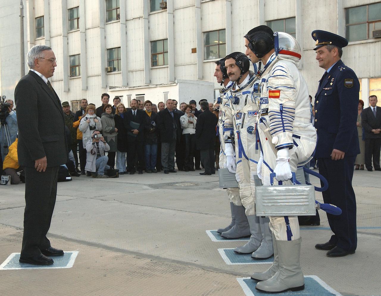Russian Aviation and Space Agency Deputy Director-General Nikolai Moiseev, left, offers a final farewell to Expedition 8 Commander and NASA Science Officer Michael Foale, third from right, Expedition 8 Soyuz Commander Alexander Kaleri and European Space Agency astronaut Pedro Duque of Spain, foreground right, prior to their departure for the launch pad, Saturday, Oct. 18, 2003, at the Baikonur Cosmodrome in Kazakhstan. The trio were launched on a Soyuz TMA-3 vehicle, arriving at the ISS on Oct. 20. Photo Credit (NASA/Bill Ingalls)