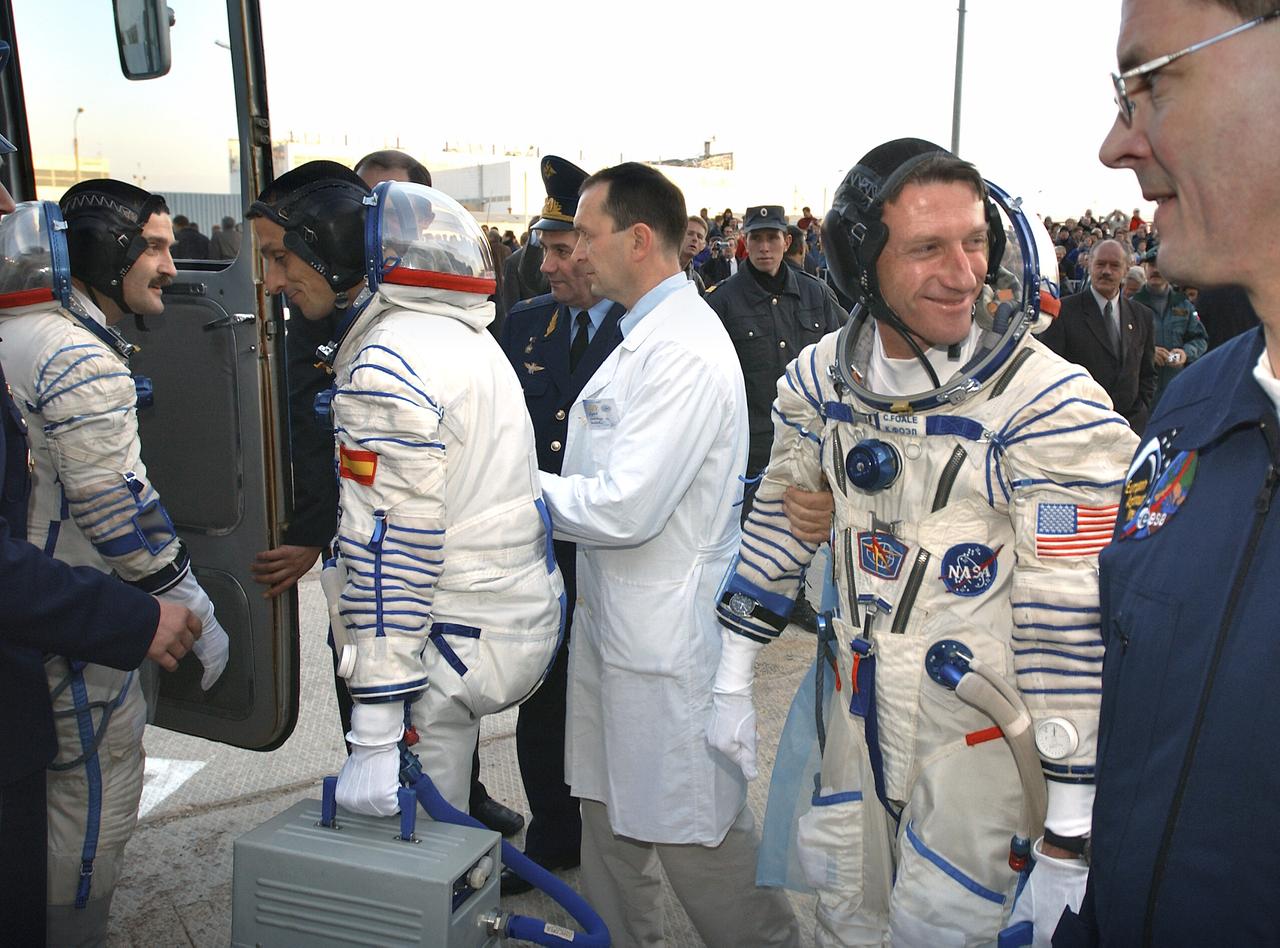 Expedition 8 Soyuz Commander Alexander Kaleri, left, European Space Agency astronaut Pedro Duque of Spain and Expedition 8 Commander and NASA Science Officer Michael Foale, right, prepare to board a bus at the Baikonur Cosmodrome in Kazakhstan, Saturday, Oct. 18, 2003, for transportation to the launch pad to liftoff in a Soyuz TMA-3 vehicle to the International Space Station. The trio arrived at the ISS Oct. 20. Photo Credit (NASA/Bill Ingalls)