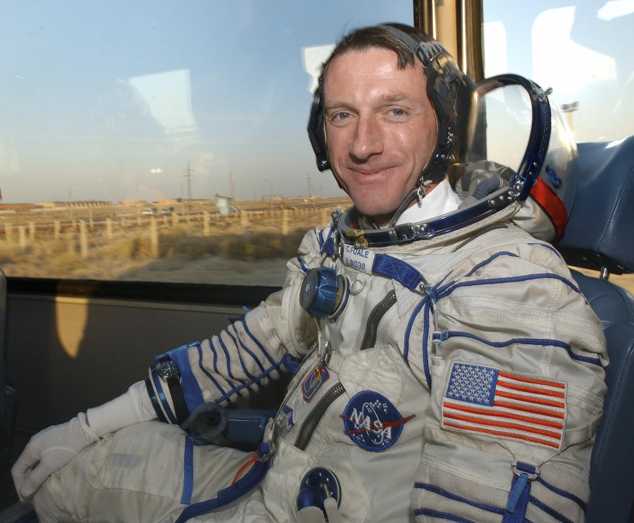 Expedition 8 Commander and NASA Science Officer Michael Foale smiles for the camera during the short bus ride to the launch pad for liftoff in a Soyuz TMA-3 vehicle to the International Space Station, Saturday, Oct. 18, 2003, at the Baikonur Cosmodrome, Kazakhstan. Photo Credit (NASA/Bill Ingalls)