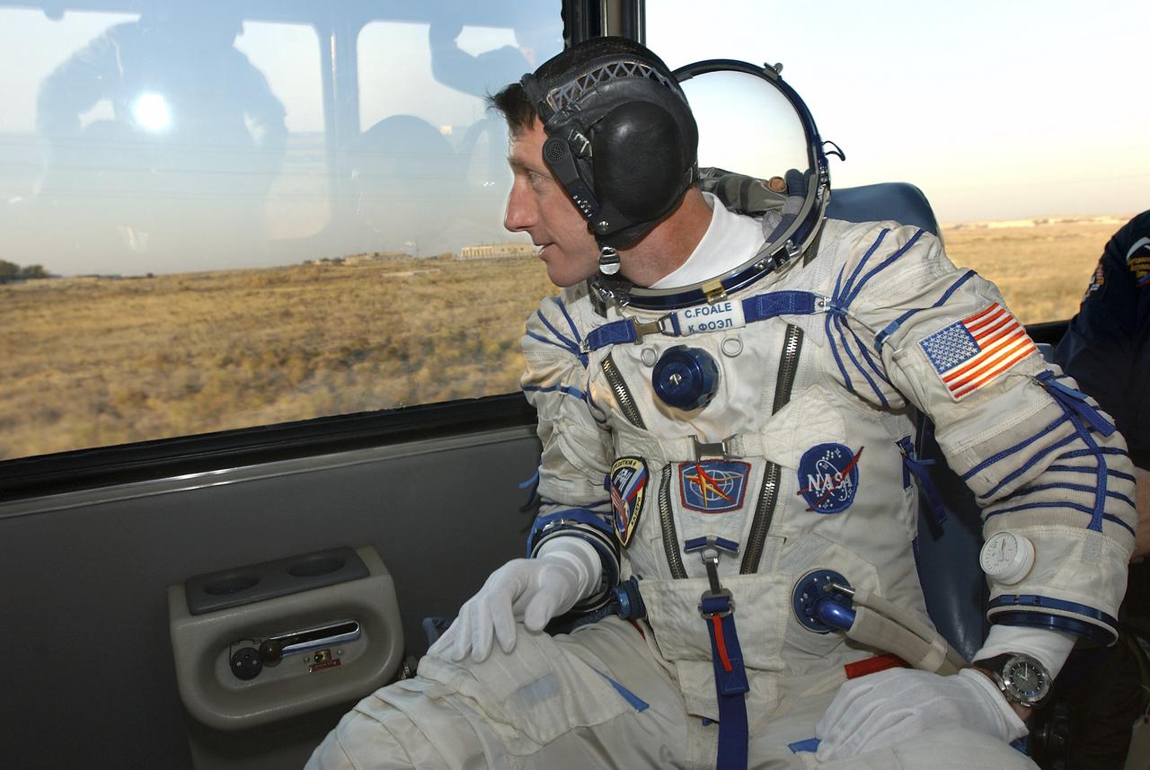 Expedition 8 Commander and NASA Science Officer Michael Foale looks out the window during the short bus ride to the launch pad for liftoff in a Soyuz TMA-3 vehicle to the International Space Station at the Baikonur Cosmodrome in Kazakhstan, Saturday, Oct. 18, 2003. Photo Credit (NASA/Bill Ingalls)