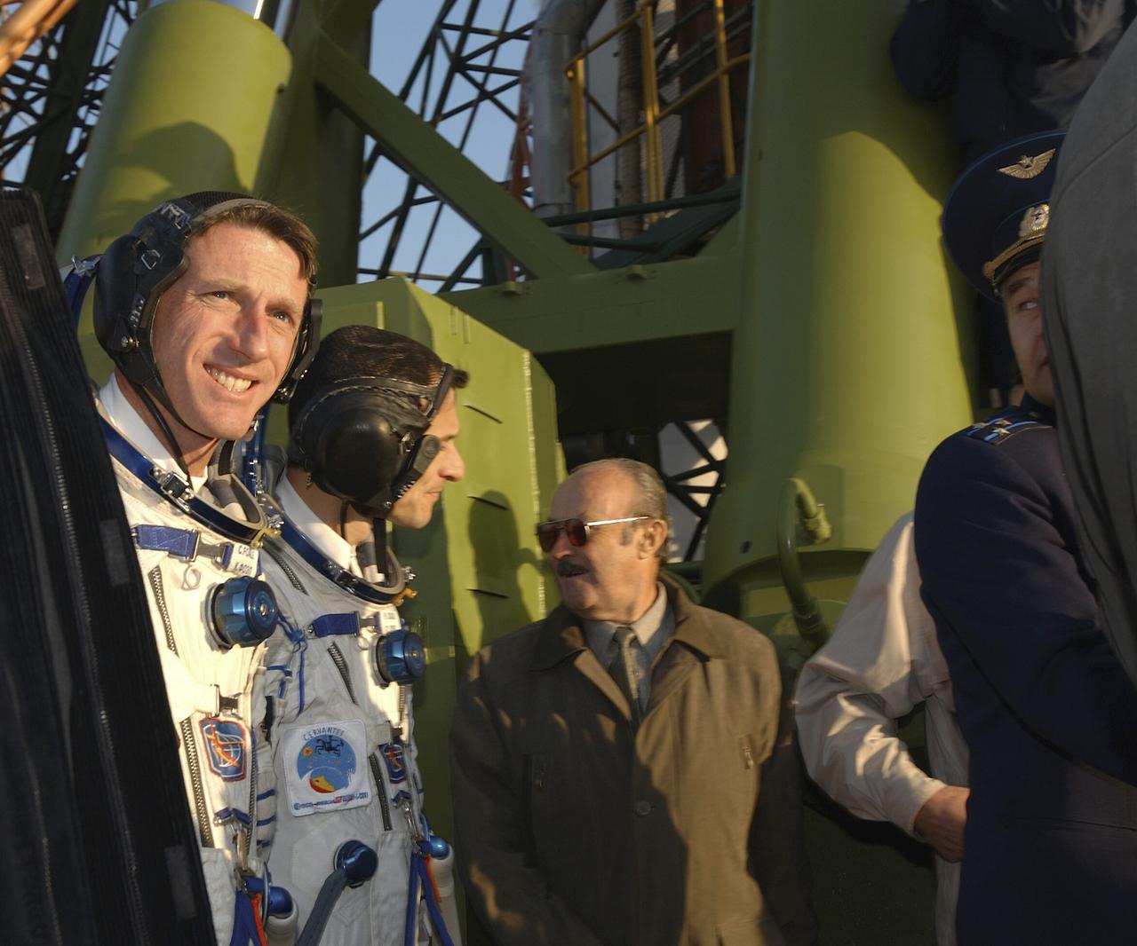 Expedition 8 Commander and NASA Science Officer Michael Foale, foreground, along with European Space Agency astronaut Pedro Duque, background, walk to the base of the Soyuz rocket at the Baikonur Cosmodrome in Kazakhstan, Saturday, Oct. 18, 2003. Photo Credit (NASA/Bill Ingalls)