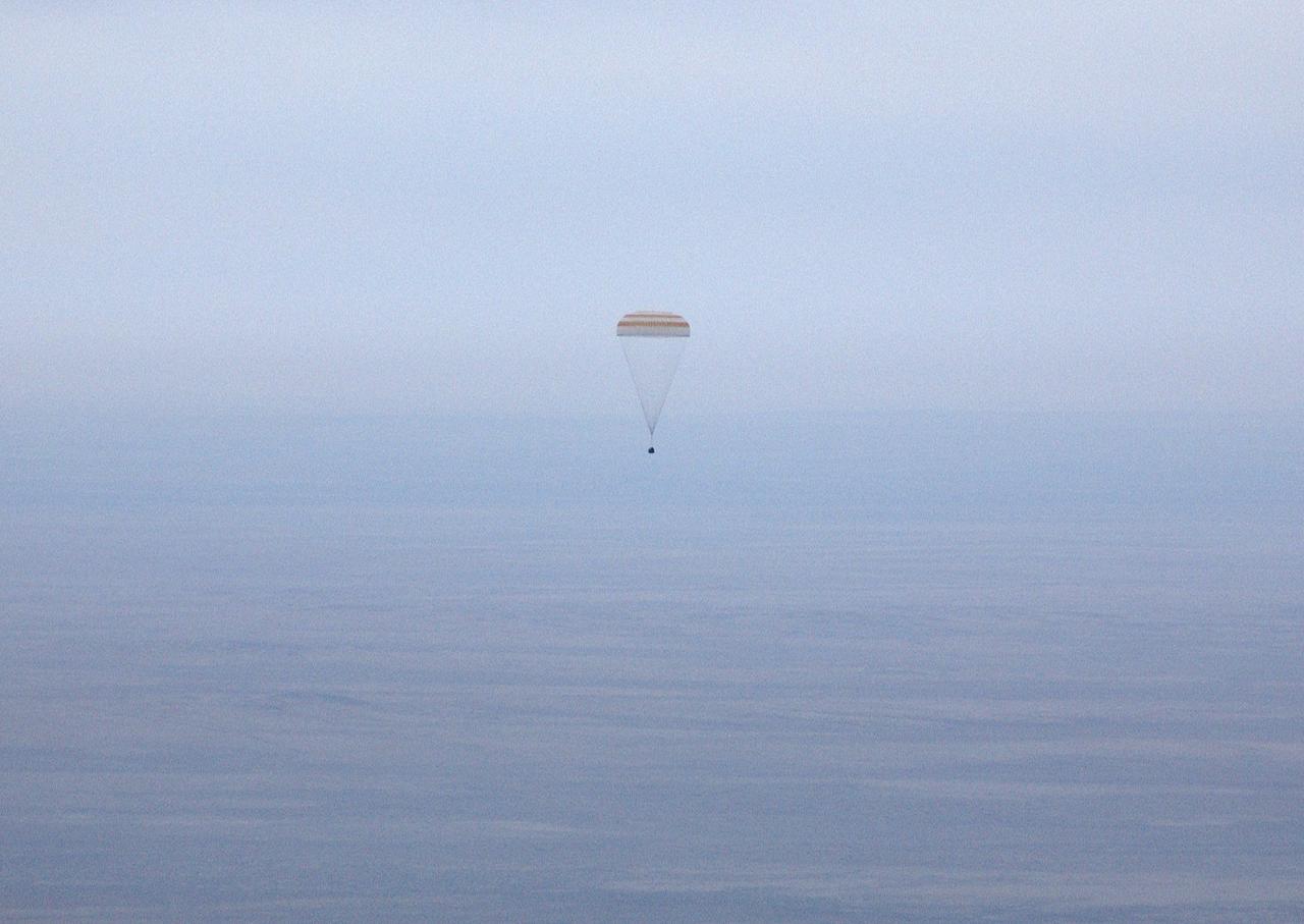 The Soyuz TMA-2 spacecraft carrying cosmonaut Yuri I. Malenchenko, Expedition 7 Mission Commander; astronaut Edward T. Lu, NASA International Space Station Science Officer and Flight Engineer; and European Space Agency (ESA) astronaut Pedro Duque of Spain floats to a landing in Kazakhstan on Monday, October 27, 2003 at 9:41 p.m. (EST). Photo Credit: (NASA/Bill Ingalls)