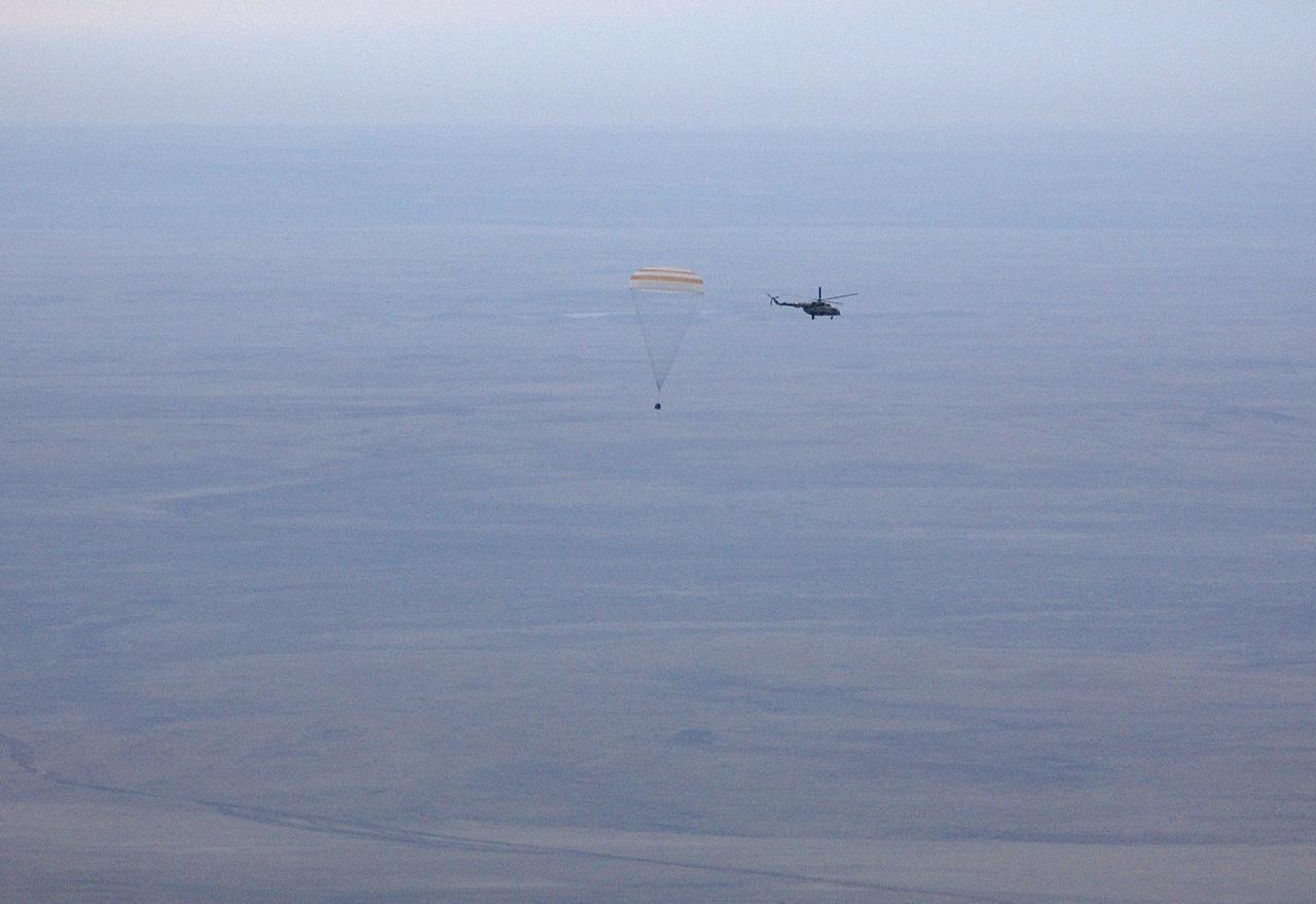 The Soyuz TMA-2 spacecraft carrying cosmonaut Yuri I. Malenchenko, Expedition 7 Mission Commander; astronaut Edward T. Lu, NASA International Space Station Science Officer and Flight Engineer; and European Space Agency (ESA) astronaut Pedro Duque of Spain floats to a landing in Kazakhstan on Monday, October 27, 2003 at 9:41 p.m. (EST). Photo Credit: (NASA/Bill Ingalls)