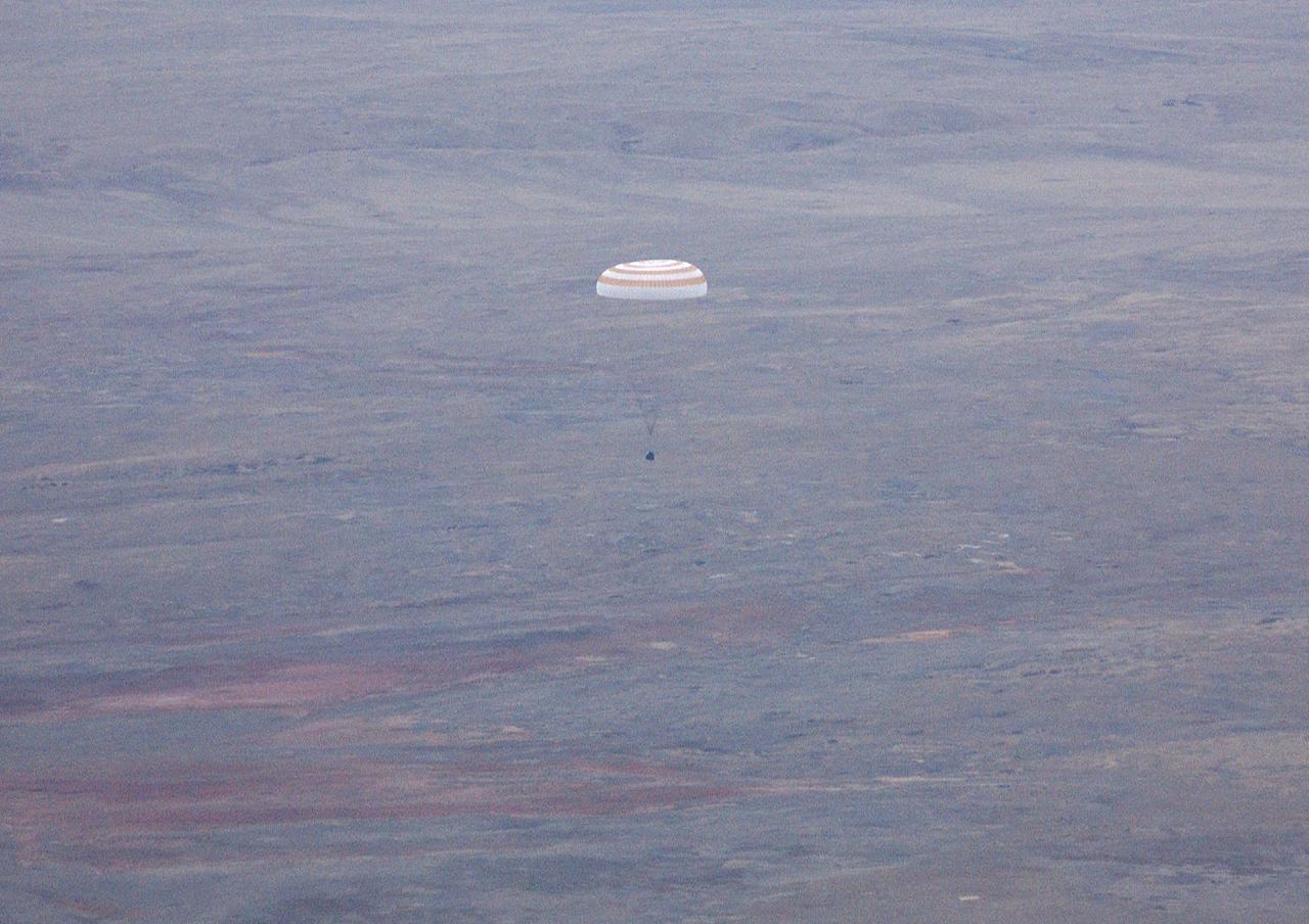 The Soyuz TMA-2 spacecraft carrying cosmonaut Yuri I. Malenchenko, Expedition 7 Mission Commander; astronaut Edward T. Lu, NASA International Space Station Science Officer and Flight Engineer; and European Space Agency (ESA) astronaut Pedro Duque of Spain floats to a landing in Kazakhstan on Monday, October 27, 2003 at 9:41 p.m. (EST). Photo Credit: (NASA/Bill Ingalls)