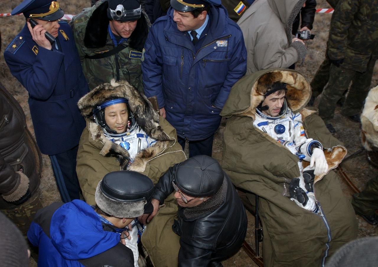Astronaut Edward T. Lu, Expedition 7 NASA International Space Station Science Officer and Flight Engineer, left and cosmonaut Yuri I. Malenchenko, Mission Commander, are seated in their chairs after being extracted from the Soyuz TMA-2 spacecraft upon their landing in Kazakhstan on Monday, October 27, 2003 at 9:41 p.m. (EST). Photo Credit: (NASA/Bill Ingalls)