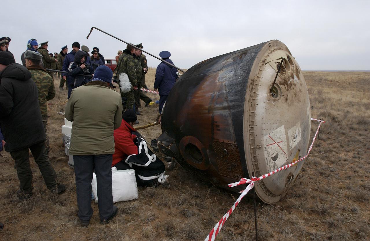 The Soyuz TMA-2 spacecraft carrying cosmonaut Yuri I. Malenchenko, Expedition 7 Mission Commander; astronaut Edward T. Lu, NASA International Space Station Science Officer and Flight Engineer; and European Space Agency (ESA) astronaut Pedro Duque of Spain is photographed on the ground after landing in Kazakhstan on Monday, October 27, 2003 at 9:41 p.m. (EST).  Photo Credit: (NASA/Bill Ingalls)