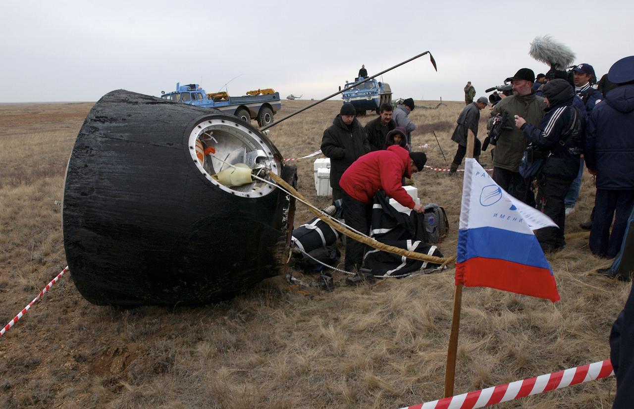 The Soyuz TMA-2 spacecraft carrying cosmonaut Yuri I. Malenchenko, Expedition 7 Mission Commander; astronaut Edward T. Lu, NASA International Space Station Science Officer and Flight Engineer; and European Space Agency (ESA) astronaut Pedro Duque of Spain is photographed on the ground after landing in Kazakhstan on Monday, October 27, 2003 at 9:41 p.m. (EST).  Photo Credit: (NASA/Bill Ingalls)