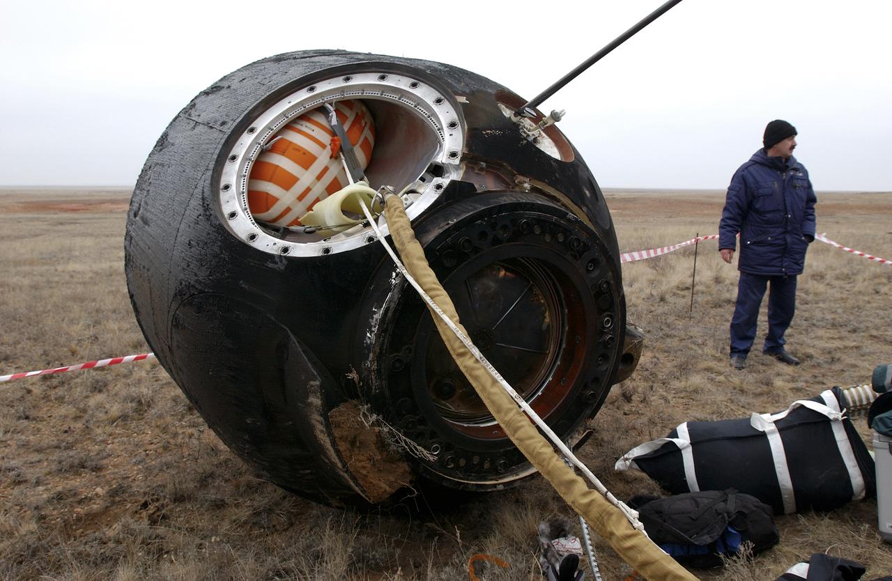 The Soyuz TMA-2 spacecraft carrying cosmonaut Yuri I. Malenchenko, Expedition 7 Mission Commander; astronaut Edward T. Lu, NASA International Space Station Science Officer and Flight Engineer; and European Space Agency (ESA) astronaut Pedro Duque of Spain is photographed on the ground after landing in Kazakhstan on Monday, October 27, 2003 at 9:41 p.m. (EST). Photo Credit: (NASA/Bill Ingalls)