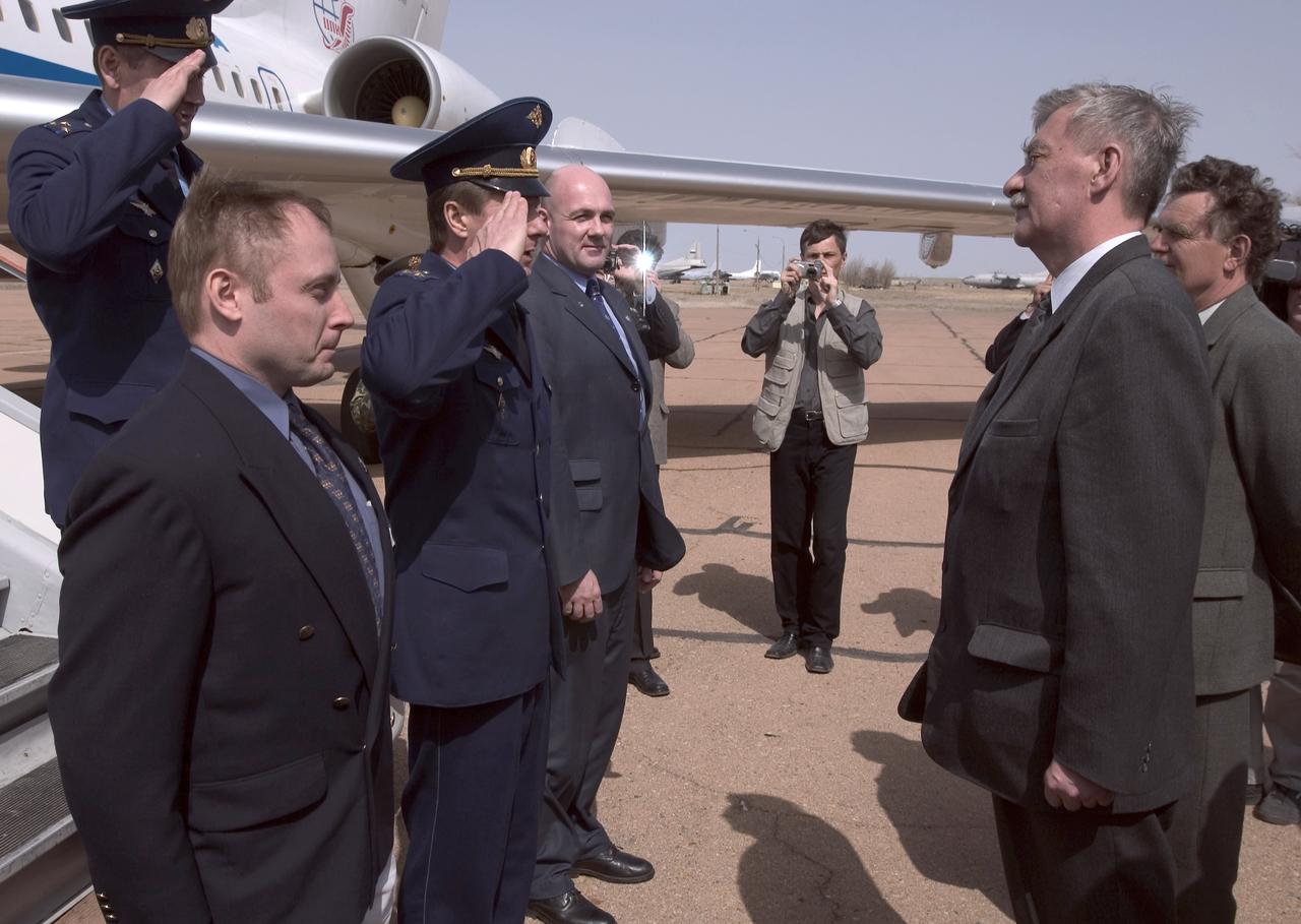 Expedition 9 Flight Engineer and NASA International Space Station Science Officer Mike Fincke, left, Expedition 9 Commander Gennady Padalka and European Space Agency astronaut Andre Kuipers of the Netherlands, third from left, are greeted by launch officials after arriving at Baikonur, Kazakhstan, Tuesday, April 13, 2004, six days prior to their scheduled launch on board a Soyuz rocket. Kuipers, who is flying under a commercial contract between ESA (European Space Agency) and the Russian Federal Space Agency, will return to Earth with the Expedition 8 crew on April 30, 2004. Photo Credit: (NASA/Bill Ingalls)