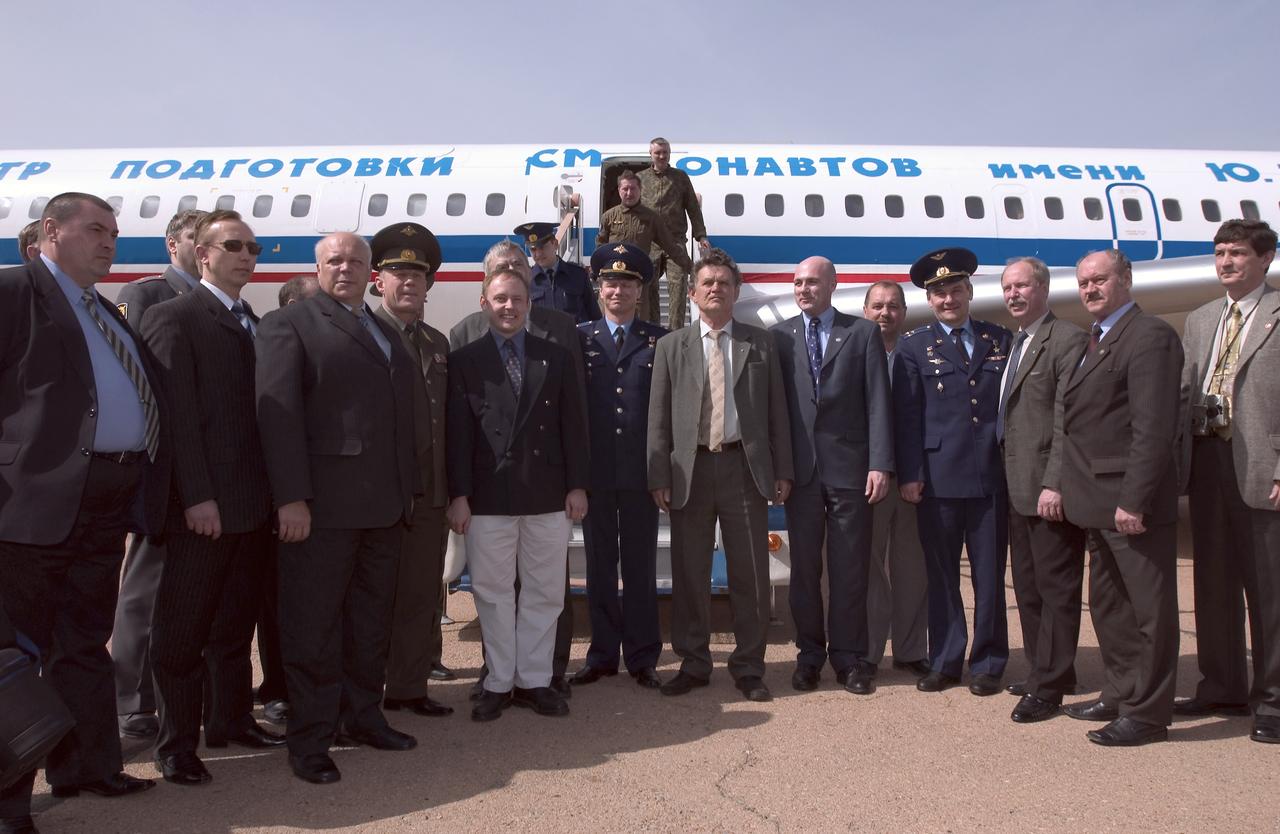 Expedition 9 Commander Gennady Padalka, center in uniform, Flight Engineer and NASA International Space Station Science Officer Mike Fincke, left of Padalka, and European Space Agency astronaut Andre Kuipers of the Netherlands, fifth from right, pose for a group photo with launch officials after arrival at Baikonur, Kazakhstan, Tuesday, April 13, 2004, six days prior to their scheduled launch on board a Soyuz rocket.  Kuipers, who is flying under a commercial contract between ESA (European Space Agency) and the Russian Federal Space Agency, will return to Earth with the Expedition 8 crew on April 30, 2004.  Photo Credit: (NASA/Bill Ingalls)