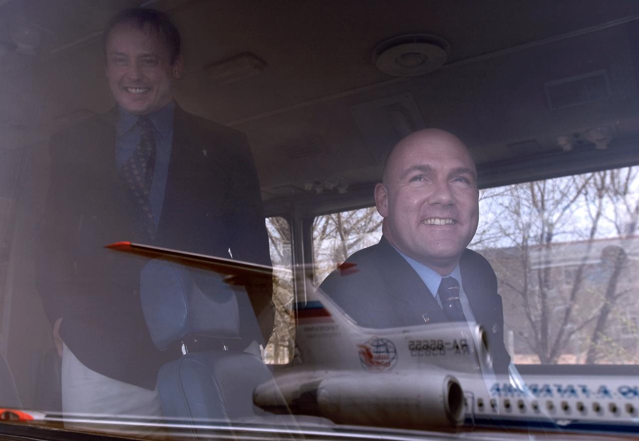 Flight Engineer and NASA International Space Station Science Officer Mike Fincke, left and European Space Agency astronaut Andre Kuipers of the Netherlands on board their bus after arrival at Baikonur, Kazakhstan, Tuesday, April 13, 2004, six days prior to their scheduled launch on board a Soyuz rocket. Kuipers, who is flying under a commercial contract between ESA and the Russian Federal Space Agency, will return to Earth with the Expedition 8 crew on April 30, 2004. Photo Credit: (NASA/Bill Ingalls)