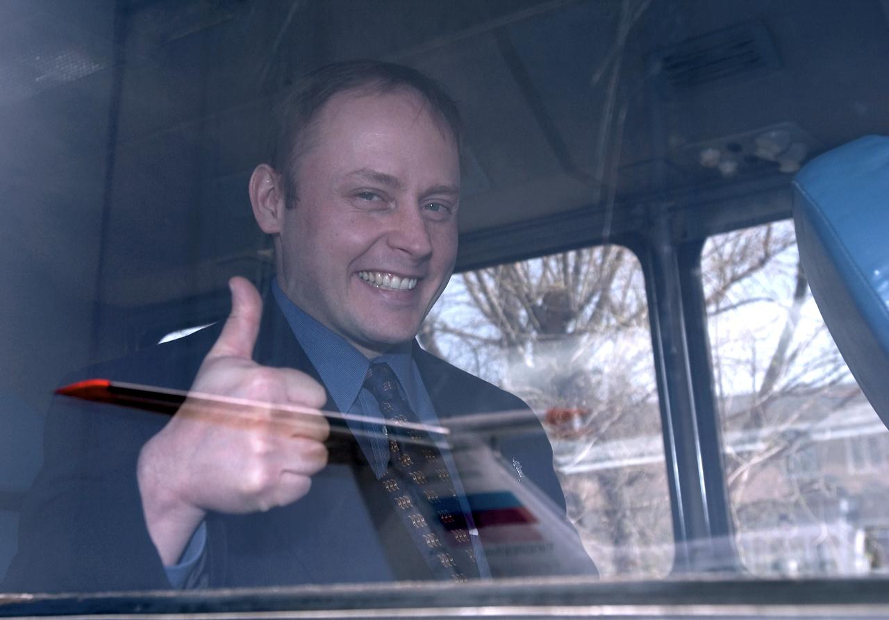 Flight Engineer and NASA International Space Station Science Officer Mike Fincke gives a thumbs up on board the bus after arrival at Baikonur, Kazakhstan, Tuesday, April 13, 2004.  Fincke is scheduled to be launched on April 19, 2004 to the International Space Station for an arrival on April 21.  He will spend six months on the ISS, replacing the Expedition 8 crew, which has been aboard the ISS since October 20, 2003.  Photo Credit: (NASA/Bill Ingalls)