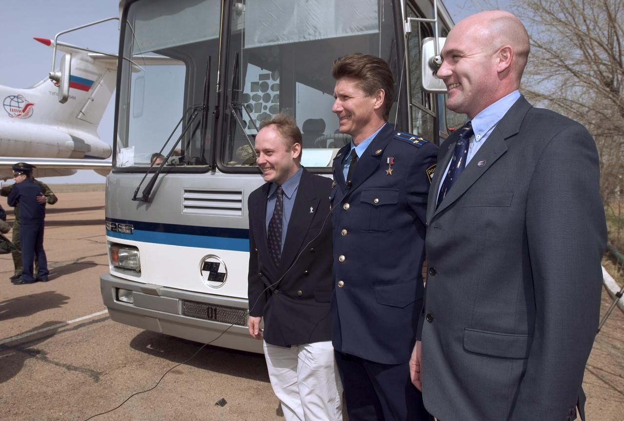 Expedition 9 Flight Engineer and NASA International Space Station Science Officer Mike Fincke, left, Expedition 9 Commander Gennady Padalka and European Space Agency astronaut Andre Kuipers of the Netherlands, right, are interviewed on camera after arrival at Baikonur, Kazakhstan, Tuesday, April 13, 2004, six days prior to their scheduled launch on board a Soyuz rocket. Kuipers, who is flying under a commercial contract between ESA and the Russian Federal Space Agency, will return to Earth with the Expedition 8 crew on April 30, 2004. Photo Credit: (NASA/Bill Ingalls)