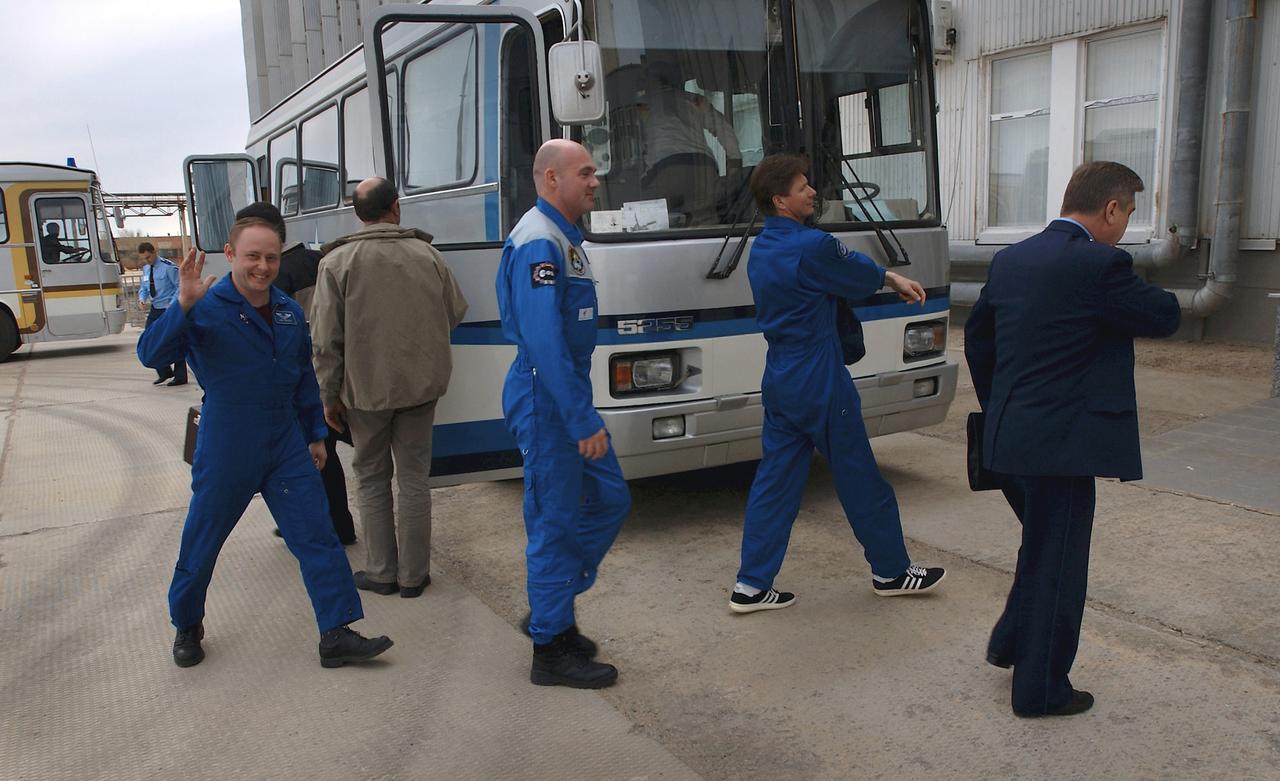 Expedition 9 NASA International Space Station Science Officer and Flight Engineer Mike Fincke, left, European Space Agency astronaut Andre Kuipers of the Netherlands, center and Expedition 9 Commander Gennady Padalka arrive at building 254 at the Baikonur Cosmodrome for their final fit check in the Soyuz, Wednesday, April 14, 2004, in Baikonur, Kazakhstan. Photo Credit: (NASA/Bill Ingalls)