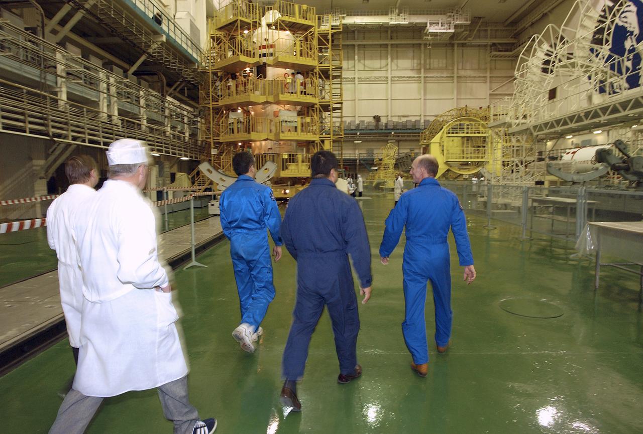 Backup Flight Engineer Salizhan Sharipov, left, Expedition 9 backup Commander Leroy Chiao, center and backup European Space Agency astronaut Gerhard Thiele of Germany walk out to the Soyuz capsule at building 254 at the Baikonur Cosmodrome for their final fit check, Wednesday, April 14, 2004, in Baikonur, Kazakhstan.  Photo Credit: (NASA/Bill Ingalls)