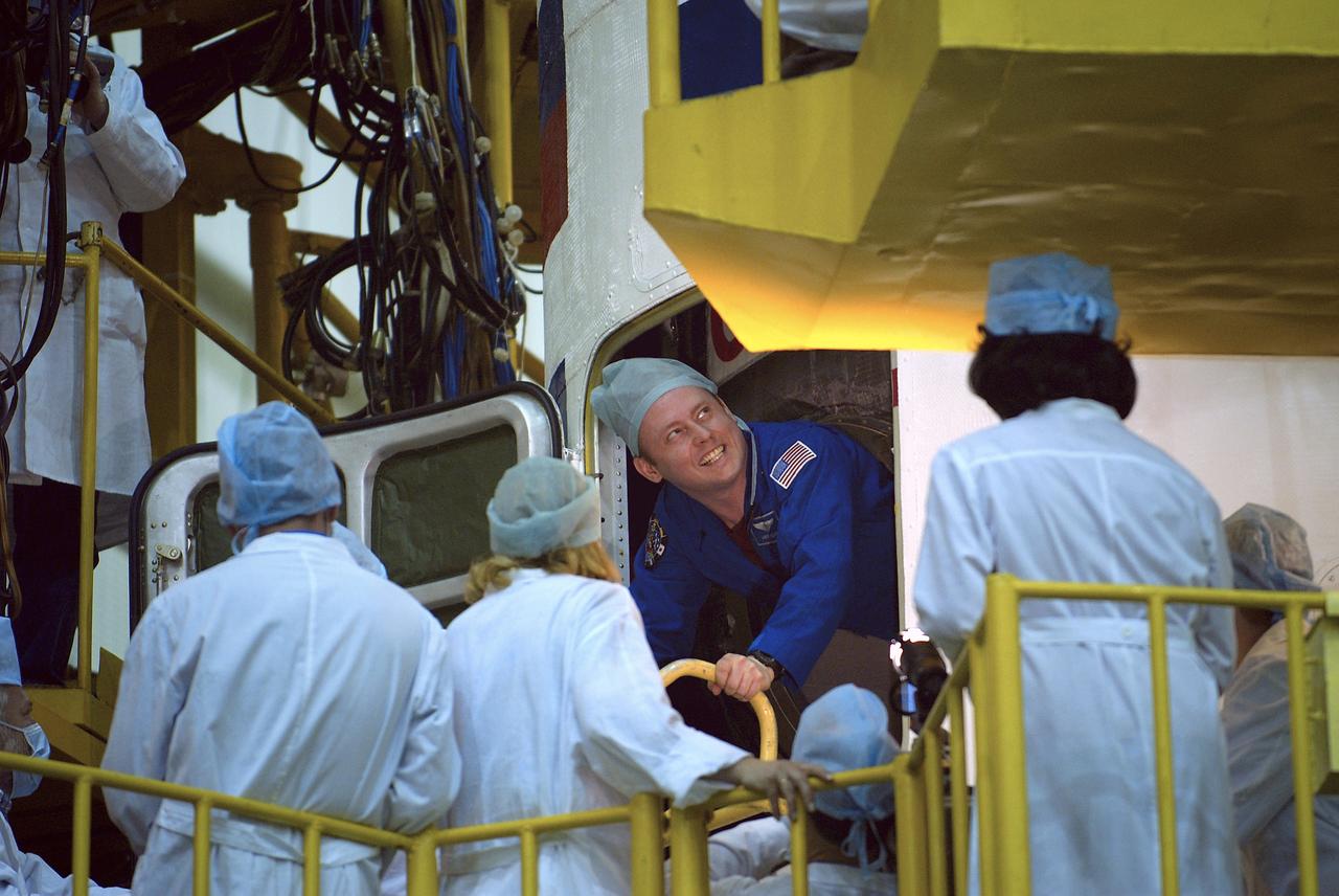 NASA Science Officer Mike Fincke climbs out of the Soyuz capsule after the crews' final fit check at building 254 at the Baikonur Cosmodrome, Wednesday, April 14, 2004, in Baikonur, Kazakhstan. Photo Credit: (NASA/Bill Ingalls)