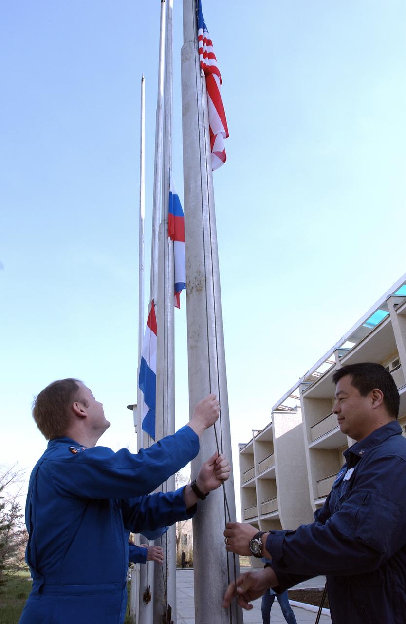 Expedition 9 Flight Engineer and NASA Science Officer Mike Fincke, left and NASA Expedition 9 backup Commander Leroy Chiao prepare to raise the American flag at the flag raising ceremony at the Cosmonaut Hotel, Thursday, April 15, 2004, Baikonur, Kazakhstan. Photo Credit: (NASA/Bill Ingalls)