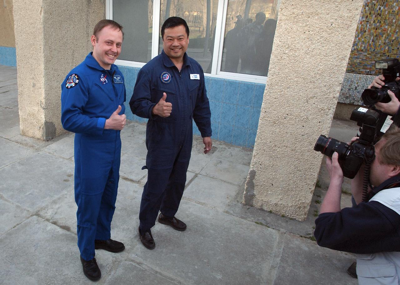 Expedition 9 Flight Engineer and NASA Science Officer Mike Fincke, left and NASA Expedition 9 backup Commander Leroy Chiao give a thumbs up after the flag raising ceremony at the Cosmonaut hotel, Thursday, April 15, 2004, in Baikonur, Kazakhstan. Photo Credit: (NASA/Bill Ingalls)