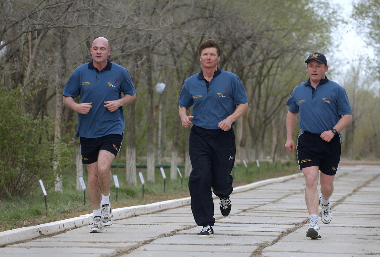 Flight Engineer and European Space Agency astronaut Andre Kuipers of the Netherlands, left, Expedition 9 Commander Gennady Padalka, center and NASA Science Officer Mike Fincke jog on the grounds of the Cosmonaut Hotel, Friday, April 16, 2004, in Baikonur, Kazakhstan. Photo Credit: (NASA/Bill Ingalls)