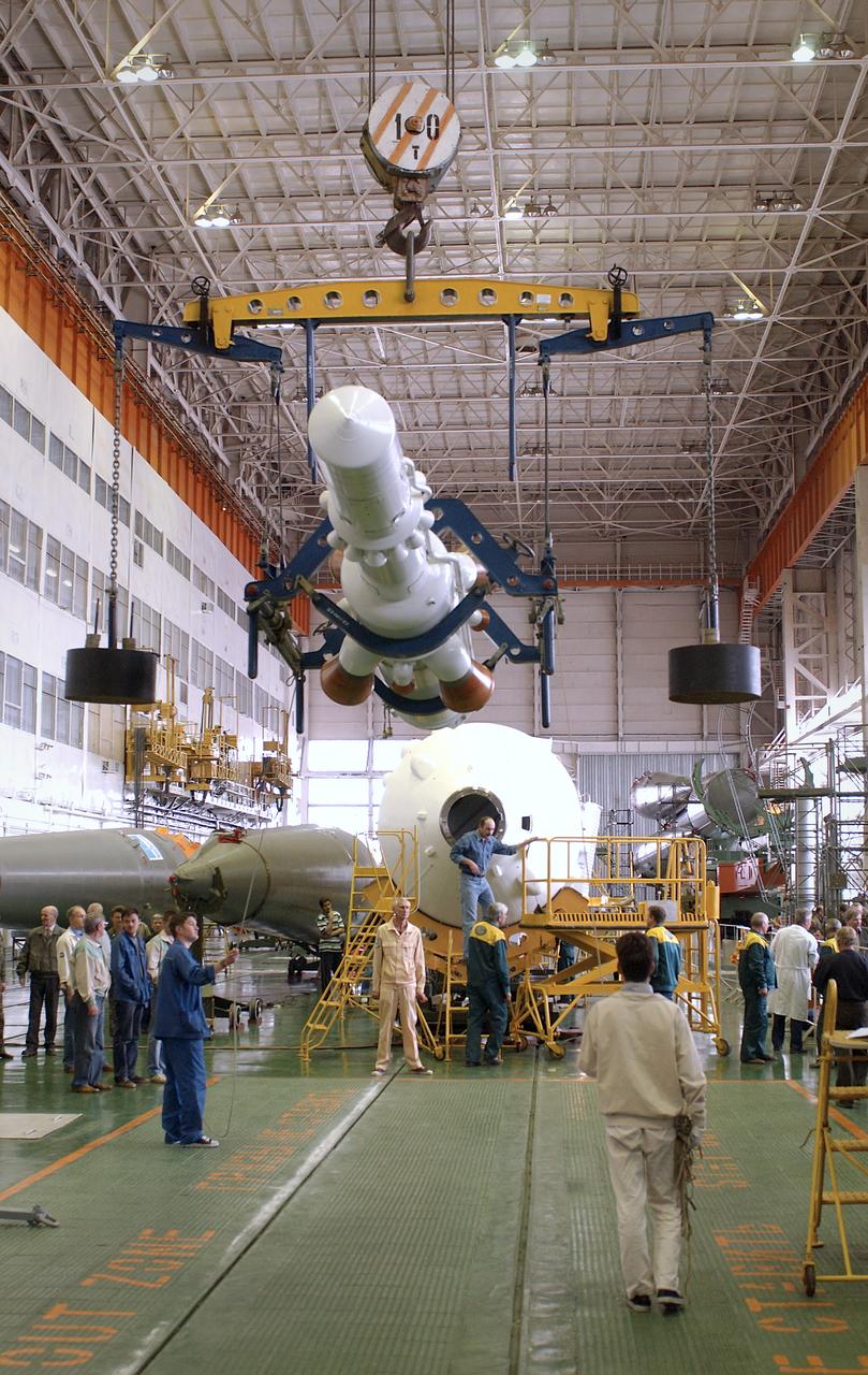 Engineers at the Baikonur Cosmodrome prepare to mate the Soyuz TMA-4 capsule with its booster rocket in preparation for a launch on April 19 of the Expedition 9 crew and a European astronaut to the International Space Station, Friday, April 16, 2004 in Baikonur, Kazakhstan. Photo Credit: (NASA/Bill Ingalls)
