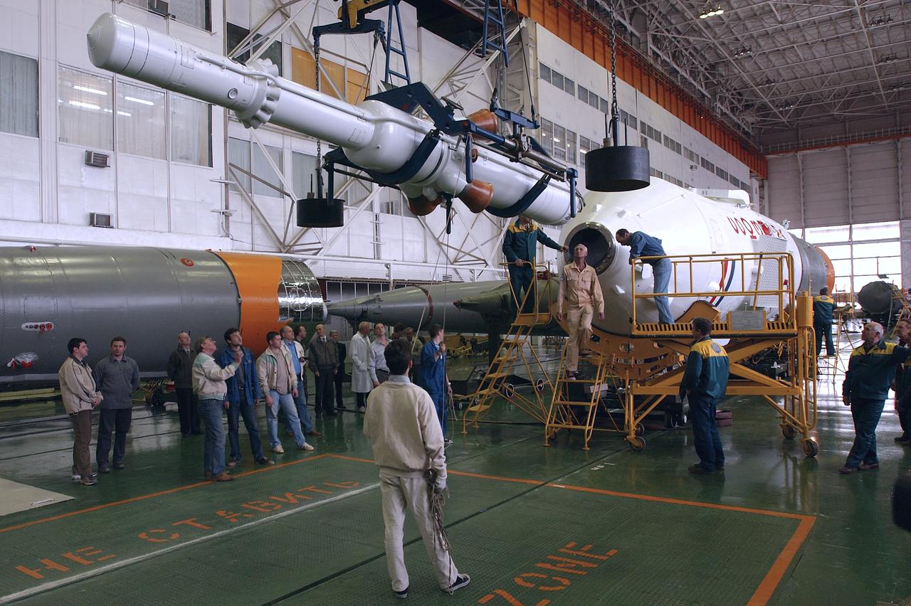 Engineers at the Baikonur Cosmodrome prepare to mate the Soyuz TMA-4 capsule with its booster rocket in preparation for a launch on April 19 of the Expedition 9 crew and a European astronaut to the International Space Station, Friday, April 16, 2004 in Baikonur, Kazakhstan. Photo Credit: (NASA/Bill Ingalls)
