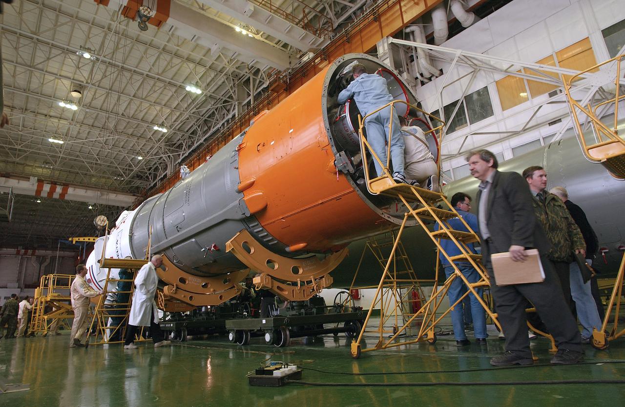 Engineers at the Baikonur Cosmodrome prepare to mate the Soyuz TMA-4 capsule with its booster rocket in preparation for a launch on April 19 of the Expedition 9 crew and a European astronaut to the International Space Station, Friday, April 16, 2004 in Baikonur, Kazakhstan. Photo Credit: (NASA/Bill Ingalls)
