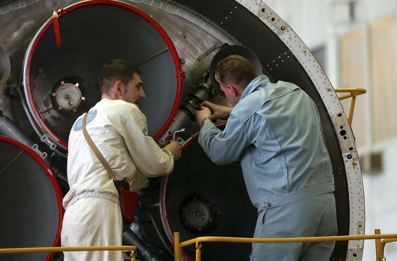 Engineers at the Baikonur Cosmodrome prepare to mate the Soyuz TMA-4 capsule with its booster rocket in preparation for a launch on April 19 of the Expedition 9 crew and a European astronaut to the International Space Station, Friday, April 16, 2004 in Baikonur, Kazakhstan. Photo Credit: (NASA/Bill Ingalls)