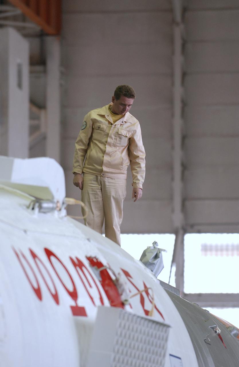 Engineers at the Baikonur Cosmodrome prepare to mate the Soyuz TMA-4 capsule with its booster rocket in preparation for a launch on April 19 of the Expedition 9 crew and a European astronaut to the International Space Station, Friday, April 16, 2004 in Baikonur, Kazakhstan. Photo Credit: (NASA/Bill Ingalls)