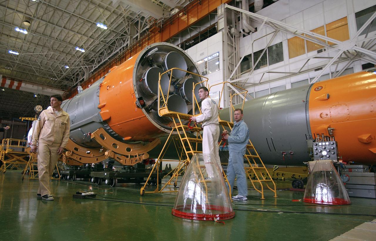 Engineers at the Baikonur Cosmodrome prepare to mate the Soyuz TMA-4 capsule with its booster rocket in preparation for a launch on April 19 of the Expedition 9 crew and a European astronaut to the International Space Station, Friday, April 16, 2004 in Baikonur, Kazakhstan. Photo Credit: (NASA/Bill Ingalls)