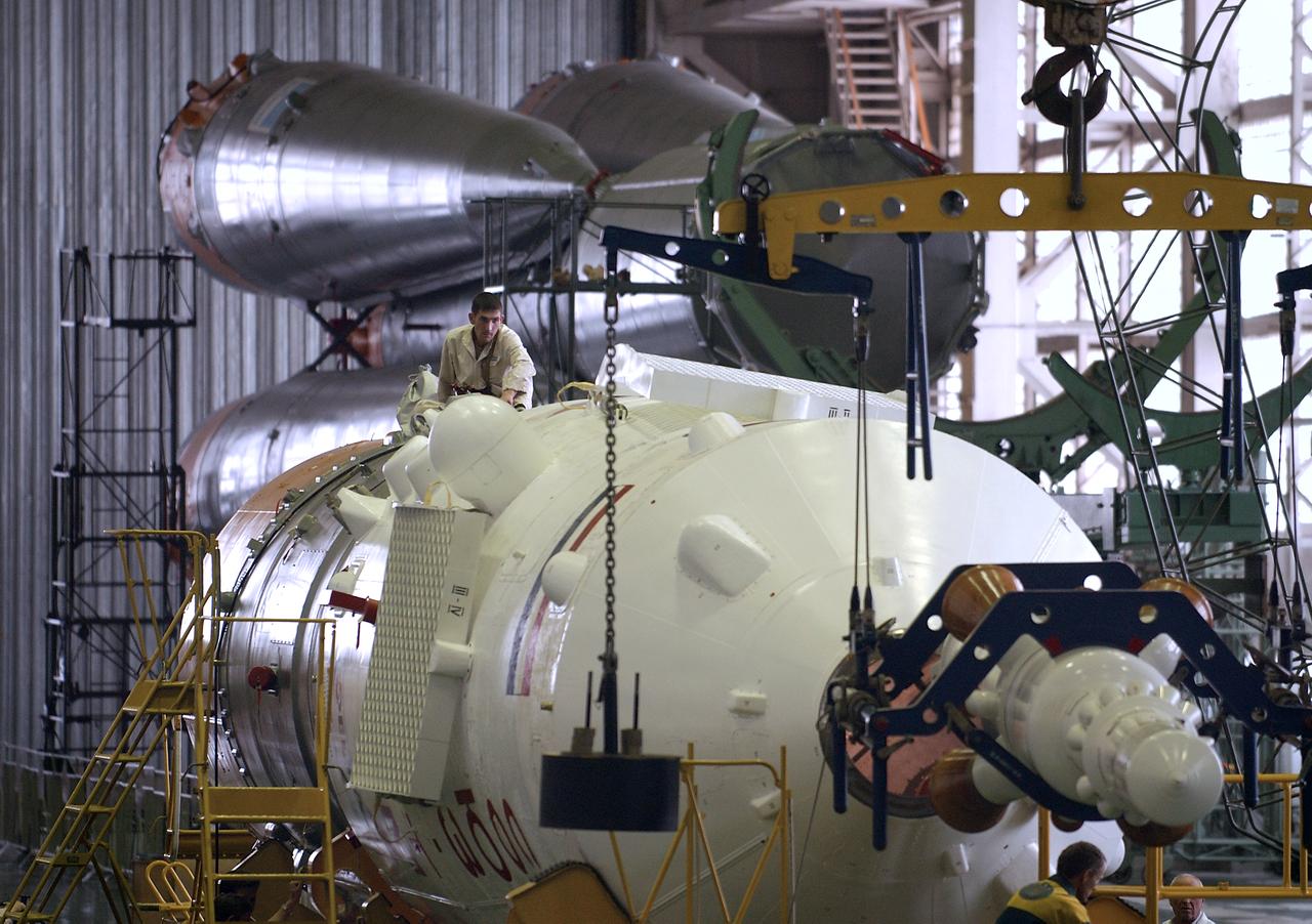 Engineers at the Baikonur Cosmodrome prepare to mate the Soyuz TMA-4 capsule with its booster rocket in preparation for a launch on April 19 of the Expedition 9 crew and a European astronaut to the International Space Station, Friday, April 16, 2004 in Baikonur, Kazakhstan. Photo Credit: (NASA/Bill Ingalls)
