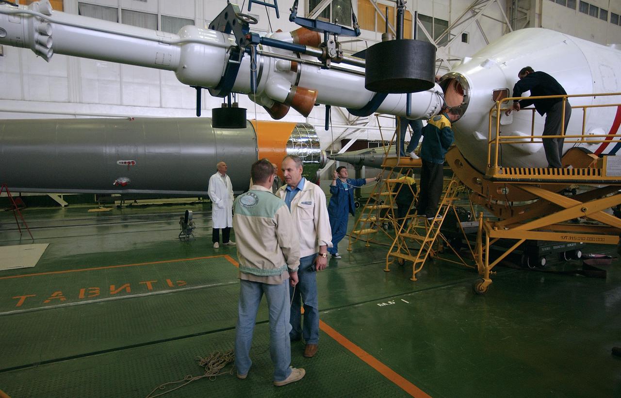 Engineers at the Baikonur Cosmodrome prepare to mate the Soyuz TMA-4 capsule with its booster rocket in preparation for a launch on April 19 of the Expedition 9 crew and a European astronaut to the International Space Station, Friday, April 16, 2004 in Baikonur, Kazakhstan. Photo Credit: (NASA/Bill Ingalls)