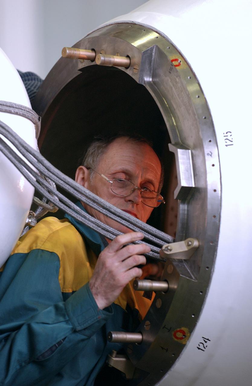 Engineers at the Baikonur Cosmodrome prepare to mate the Soyuz TMA-4 capsule with its booster rocket in preparation for a launch on April 19 of the Expedition 9 crew and a European astronaut to the International Space Station, Friday, April 16, 2004 in Baikonur, Kazakhstan. Photo Credit: (NASA/Bill Ingalls)