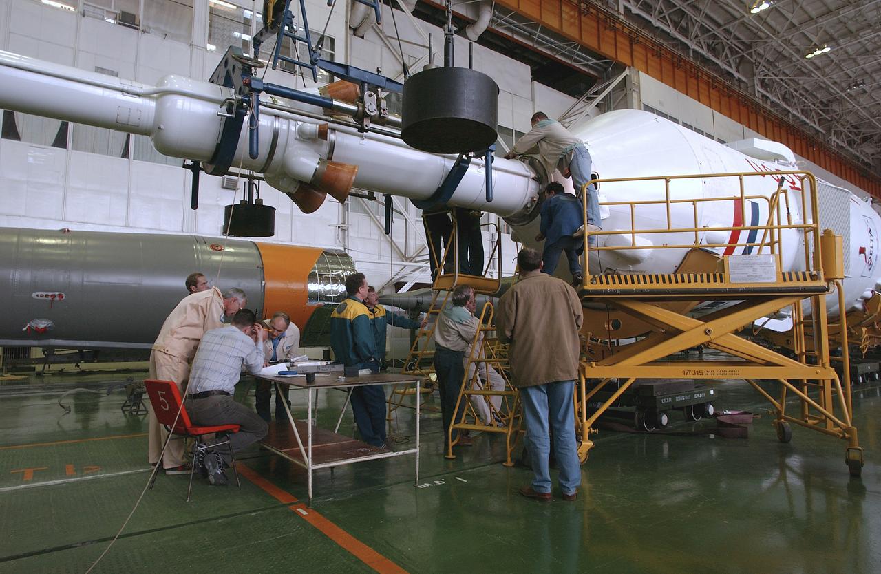 Engineers at the Baikonur Cosmodrome prepare to mate the Soyuz TMA-4 capsule with its booster rocket in preparation for a launch on April 19 of the Expedition 9 crew and a European astronaut to the International Space Station, Friday, April 16, 2004 in Baikonur, Kazakhstan. Photo Credit: (NASA/Bill Ingalls)