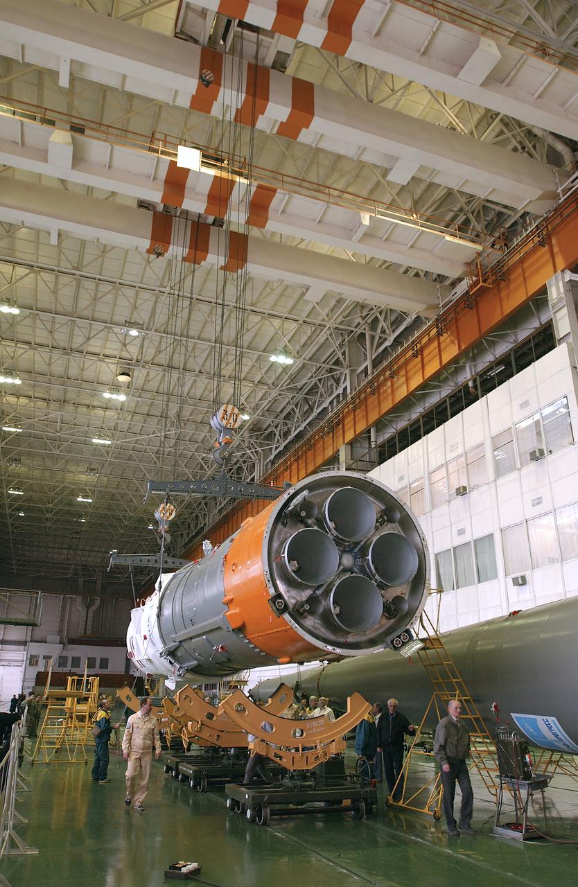 Engineers at the Baikonur Cosmodrome prepare to mate the Soyuz TMA-4 capsule with its booster rocket in preparation for a launch on April 19 of the Expedition 9 crew and a European astronaut to the International Space Station, Friday, April 16, 2004 in Baikonur, Kazakhstan. Photo Credit: (NASA/Bill Ingalls)