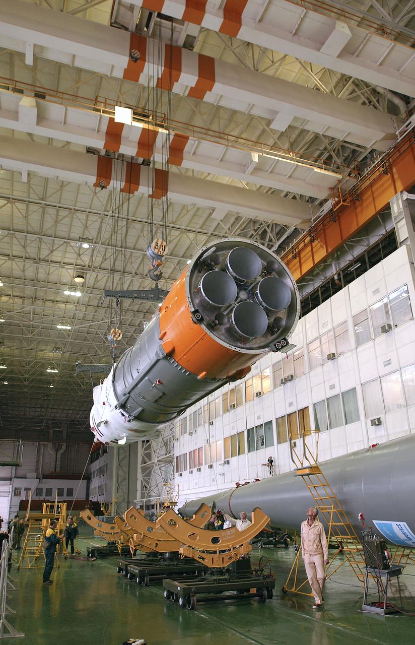 Engineers at the Baikonur Cosmodrome prepare to mate the Soyuz TMA-3 capsule with its booster rocket in preparation for a launch on April 19 of the Expedition 9 crew and a European astronaut to the International Space Station, Friday, April 16, 2004 in Baikonur, Kazakhstan. Photo Credit: (NASA/Bill Ingalls)