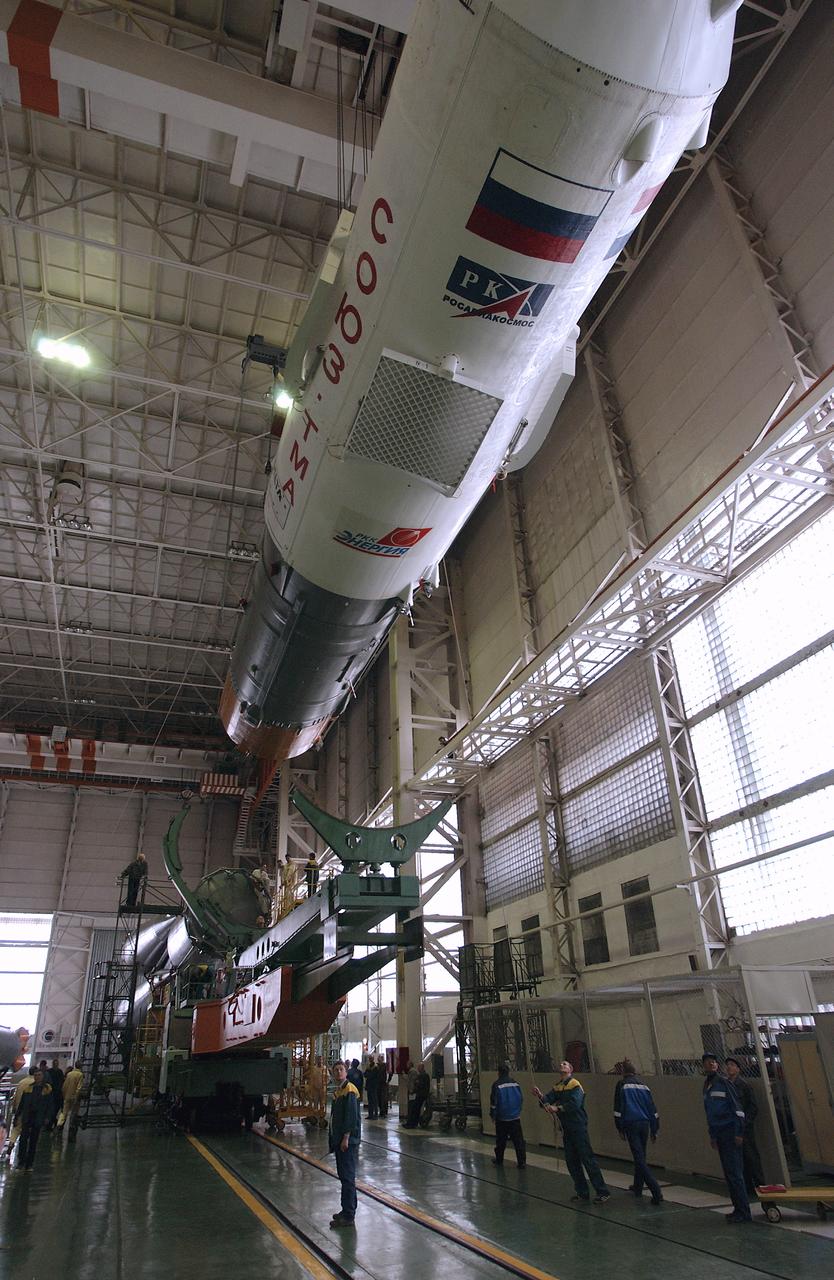 Engineers at the Baikonur Cosmodrome prepare to mate the Soyuz TMA-4 capsule with its booster rocket in preparation for a launch on April 19 of the Expedition 9 crew and a European astronaut to the International Space Station, Friday, April 16, 2004 in Baikonur, Kazakhstan. Photo Credit: (NASA/Bill Ingalls)