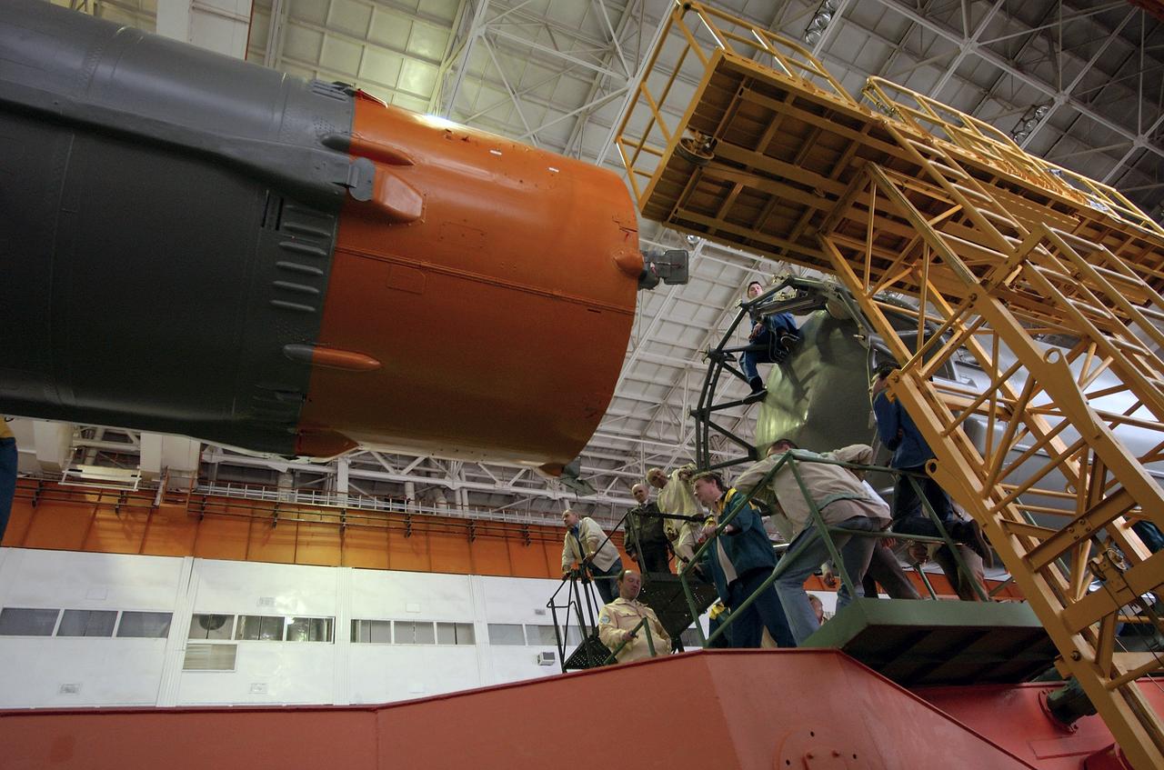 Engineers at the Baikonur Cosmodrome mate the Soyuz TMA-4 capsule with its booster rocket in preparation for a launch on April 19 of the Expedition 9 crew and a European astronaut to the International Space Station, Friday, April 16, 2004 in Baikonur, Kazakhstan. Photo Credit: (NASA/Bill Ingalls)