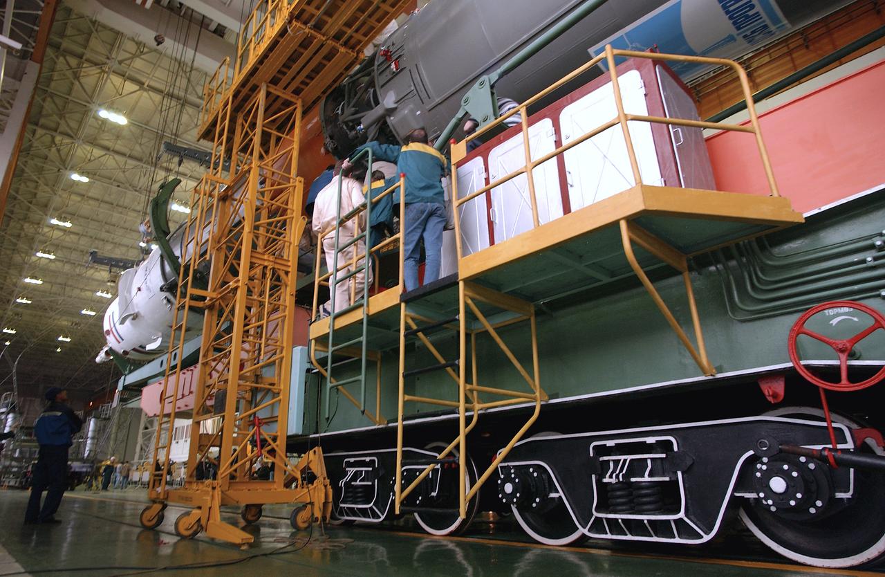 Engineers at the Baikonur Cosmodrome mate the Soyuz TMA-4 capsule with its booster rocket in preparation for a launch on April 19 of the Expedition 9 crew and a European astronaut to the International Space Station, Friday, April 16, 2004 in Baikonur, Kazakhstan. Photo Credit: (NASA/Bill Ingalls)