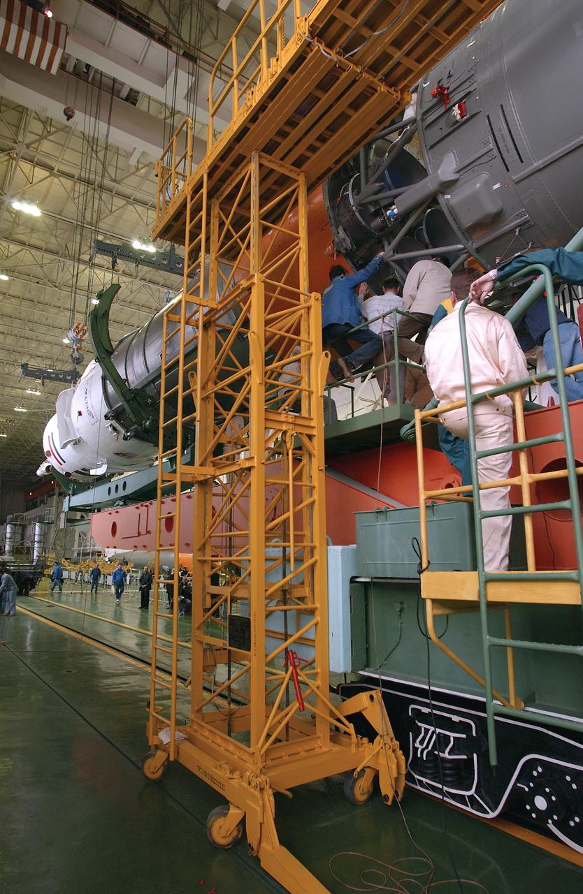 Engineers at the Baikonur Cosmodrome mate the Soyuz TMA-4 capsule with its booster rocket in preparation for a launch on April 19 of the Expedition 9 crew and a European astronaut to the International Space Station, Friday, April 16, 2004 in Baikonur, Kazakhstan. Photo Credit: (NASA/Bill Ingalls)