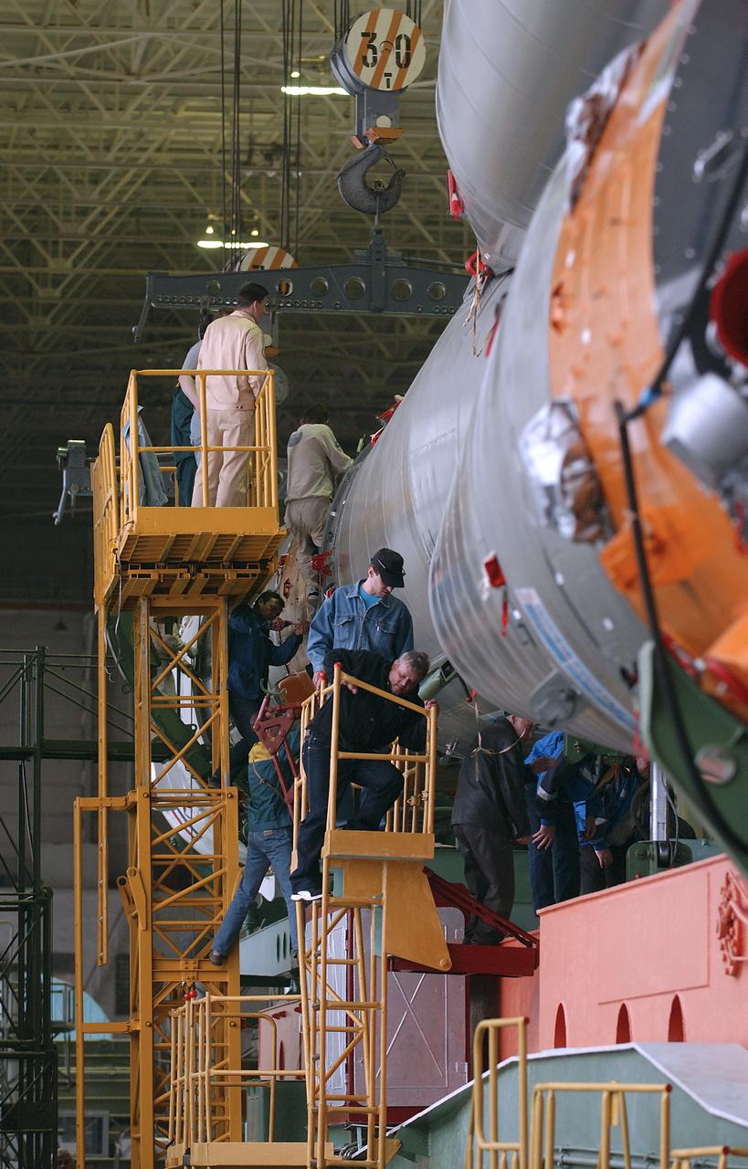 Engineers at the Baikonur Cosmodrome mated the Soyuz TMA-4 capsule with its booster rocket in preparation for a launch on April 19 of the Expedition 9 crew and a European astronaut to the International Space Station, Friday, April 16, 2004 in Baikonur, Kazakhstan. Photo Credit: (NASA/Bill Ingalls)